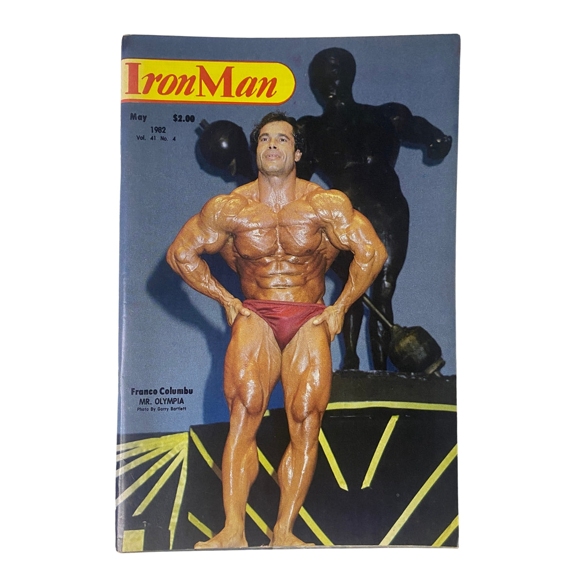 IronMan Magazine May 1982 Vol 41 No. 4 featuring Franco Columbu on the cover, showcasing the bodybuilder in a competition pose with a gold backdrop.