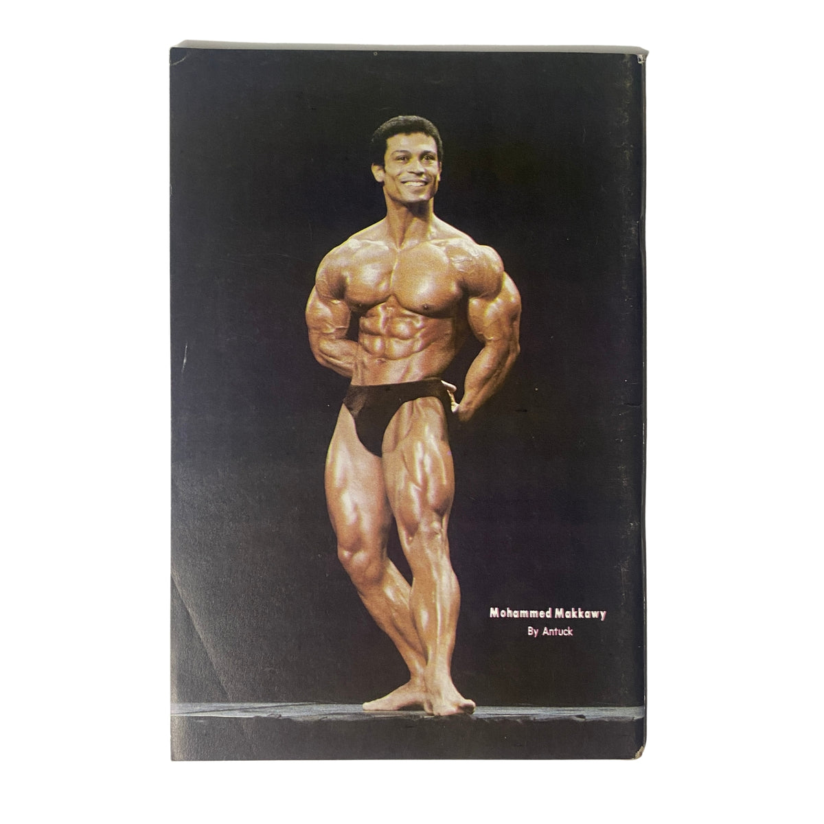 Back cover of IronMan Magazine July 1982 Vol 41 No. 5 featuring Mohammed Makkawy in a posing stance, showcasing his muscular physique. This vintage bodybuilding magazine highlights key athletes and expert insights relevant to classic bodybuilding history.