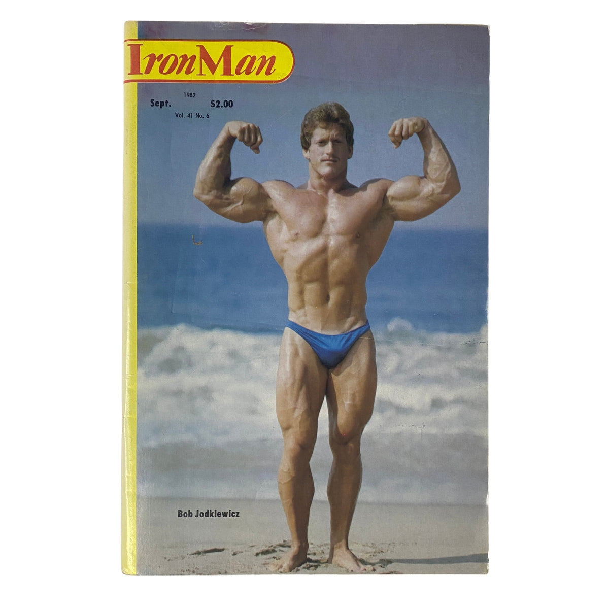 IronMan Magazine September 1982 Vol 41 No. 6 featuring Bob Jodkiewicz on the front cover, posing confidently on the beach in a blue swimsuit.