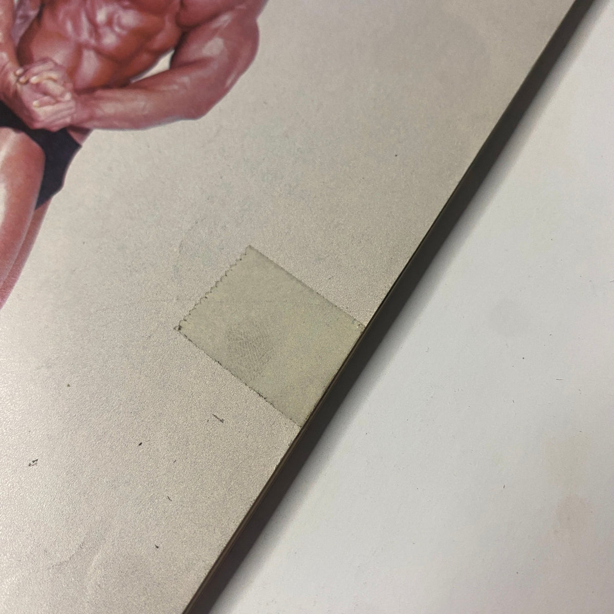 Close-up detail of the IronMan Magazine September 1984 cover showing a label area with minor wear, highlighting the condition of the vintage magazine.