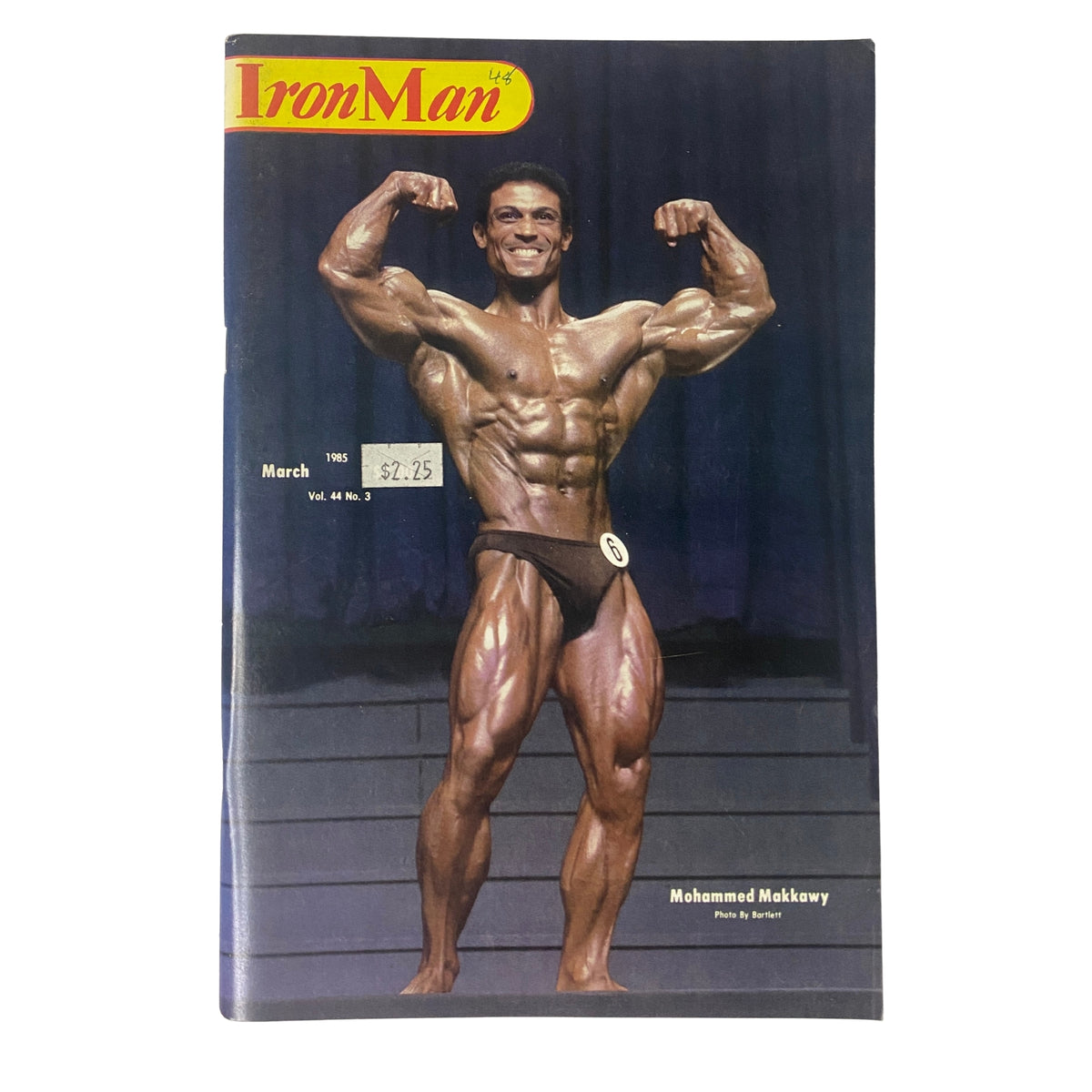 Cover of IronMan Magazine March 1985 Vol 44 No. 3 featuring Mohammed Makkawy, known for his impressive physique. The magazine showcases the artistry of bodybuilding.