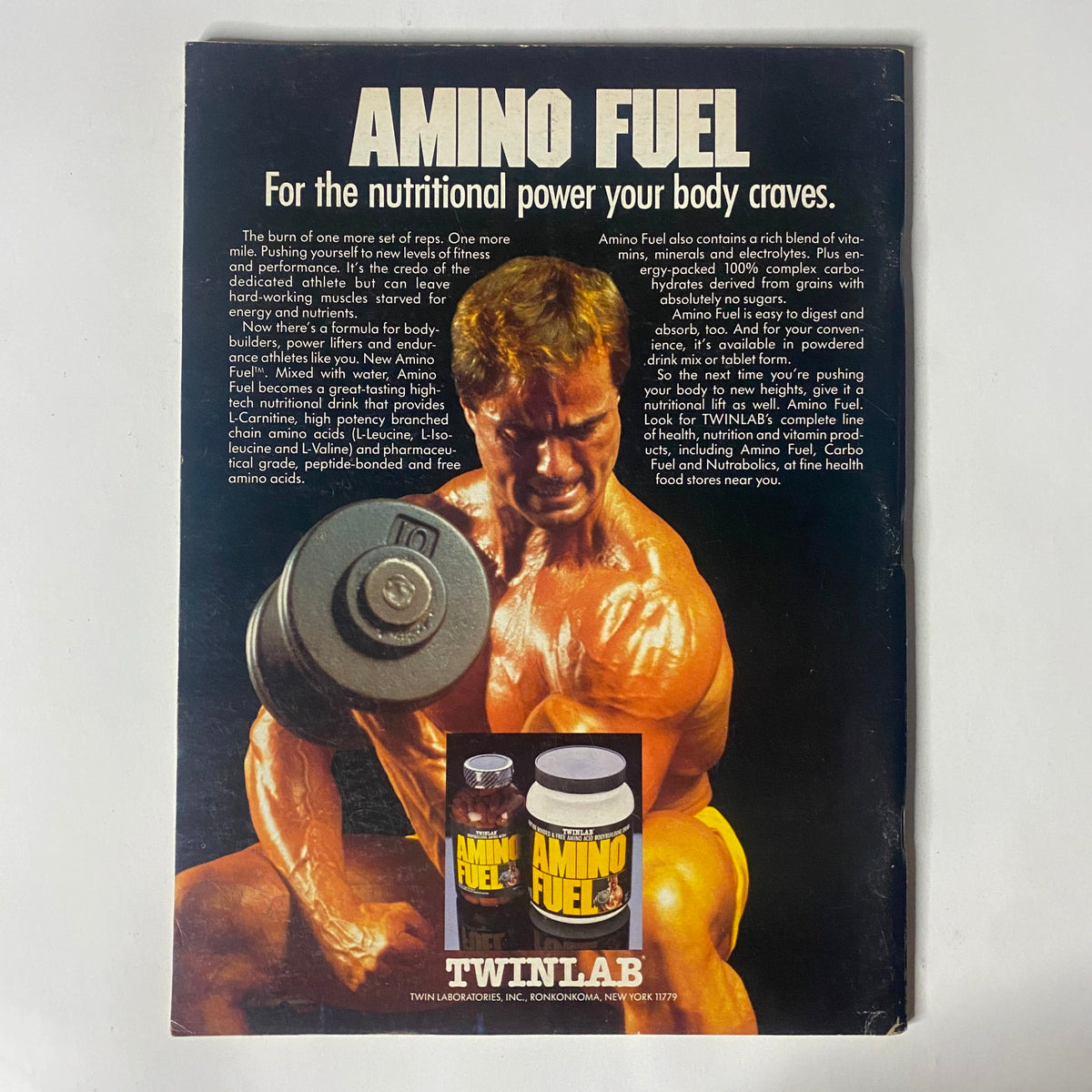 A vintage advertisement for Amino Fuel featured in IronMan Magazine July 1987, Volume 46, Number 5, showcasing a muscular man with a dumbbell and products from TwinLab, marketed for nutritional power in bodybuilding.