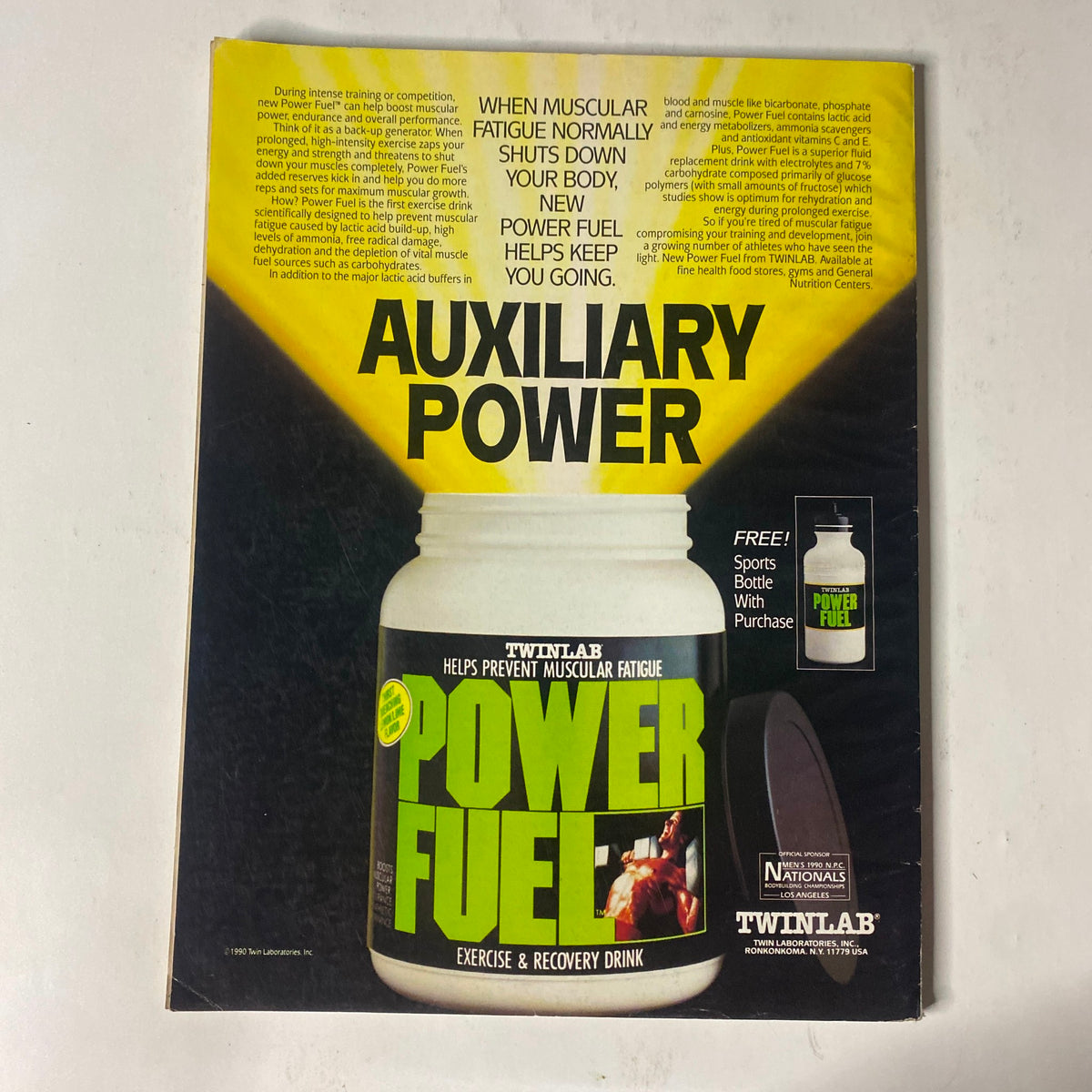 Advertisement for Twinlab's Power Fuel exercise and recovery drink on the back cover of IronMan Magazine July 1990 Vol. 49 No. 7, promoting benefits for muscular fatigue.