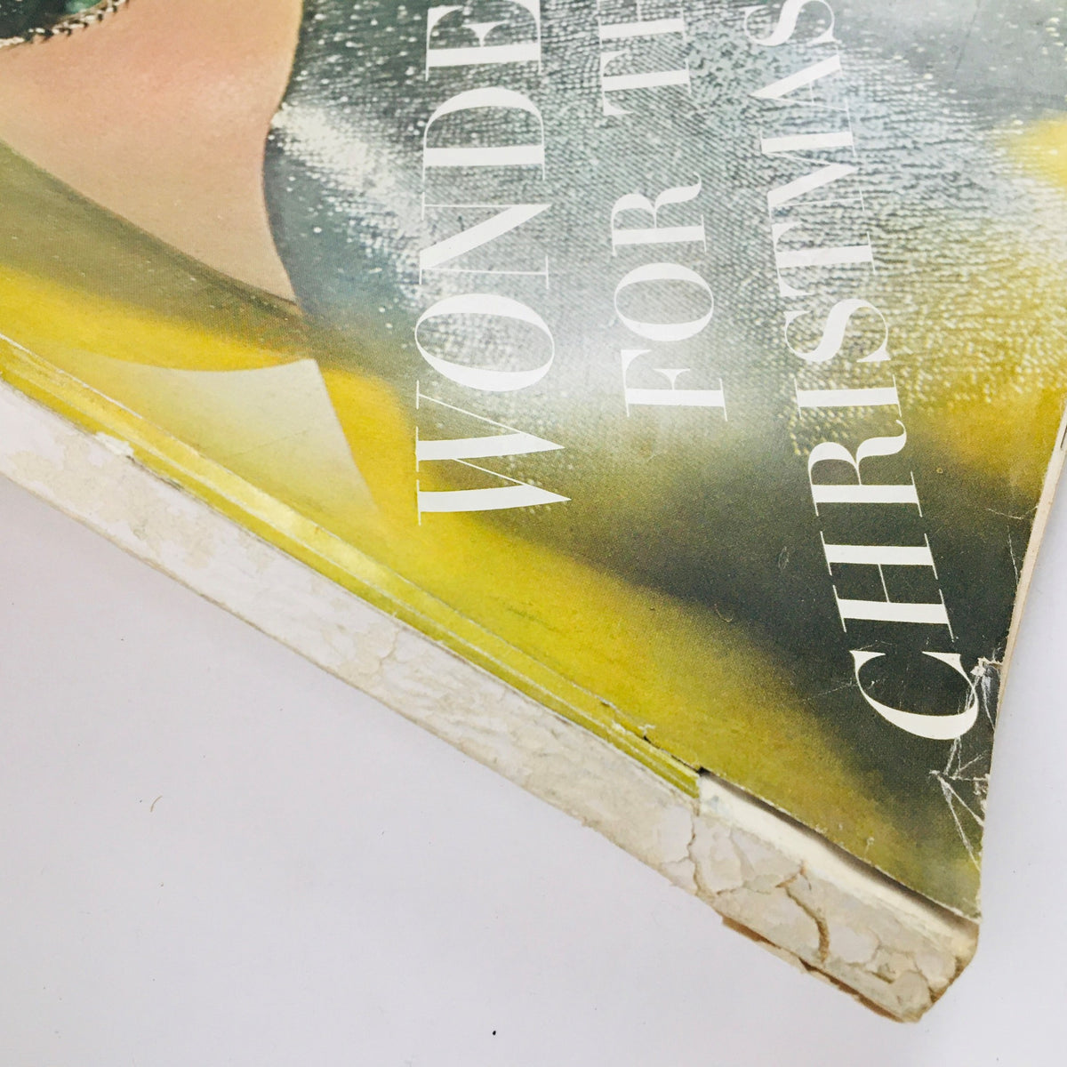 Close-up of the cover of VTG Vogue Magazine December 1964 featuring 'Wonders for the Christmas Eyes', highlighting vintage fashion and design.