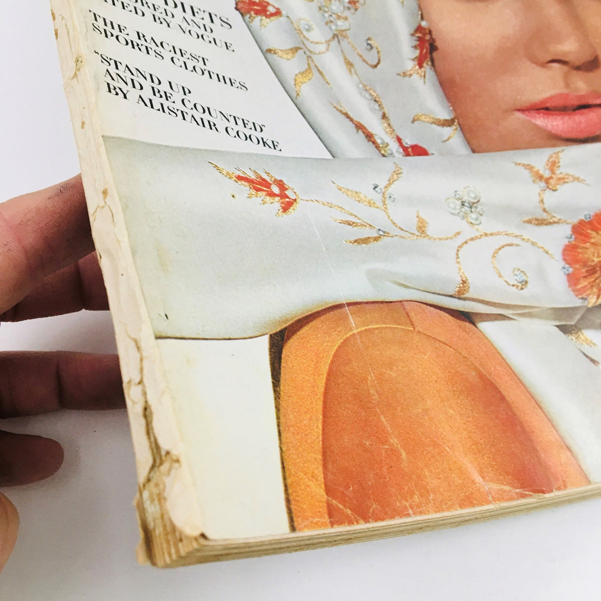 Close-up of the binding and corner of VTG Vogue Magazine from October 15, 1964 featuring a model in a stylish scarf, showcasing minor wear.