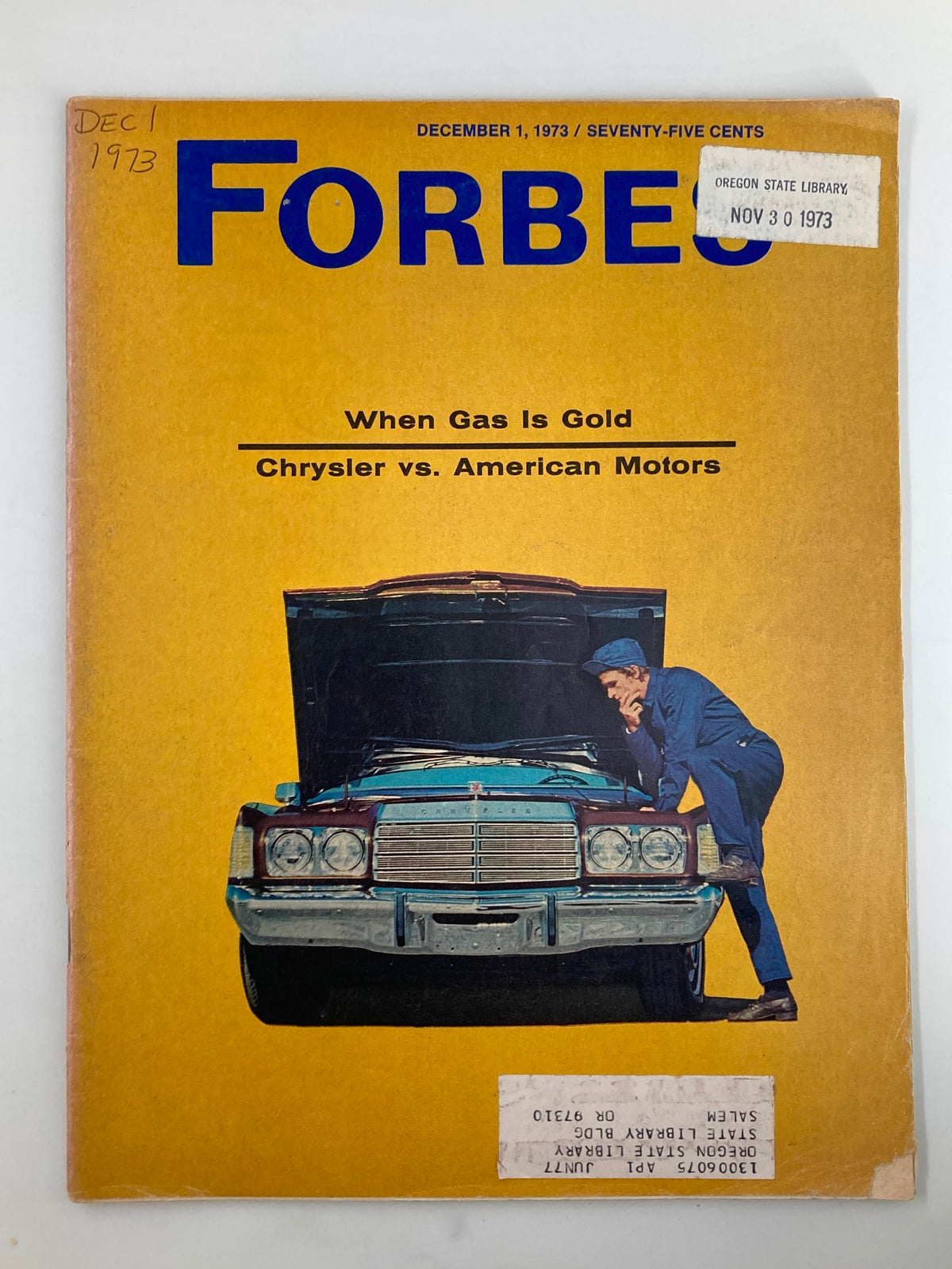 Cover of VTG Forbes Magazine December 1 1973 when gas is gold, featuring the title 'When Gas is Gold: Chrysler vs American Motors' with a vibrant yellow background and an illustration of a mechanic inspecting a car.