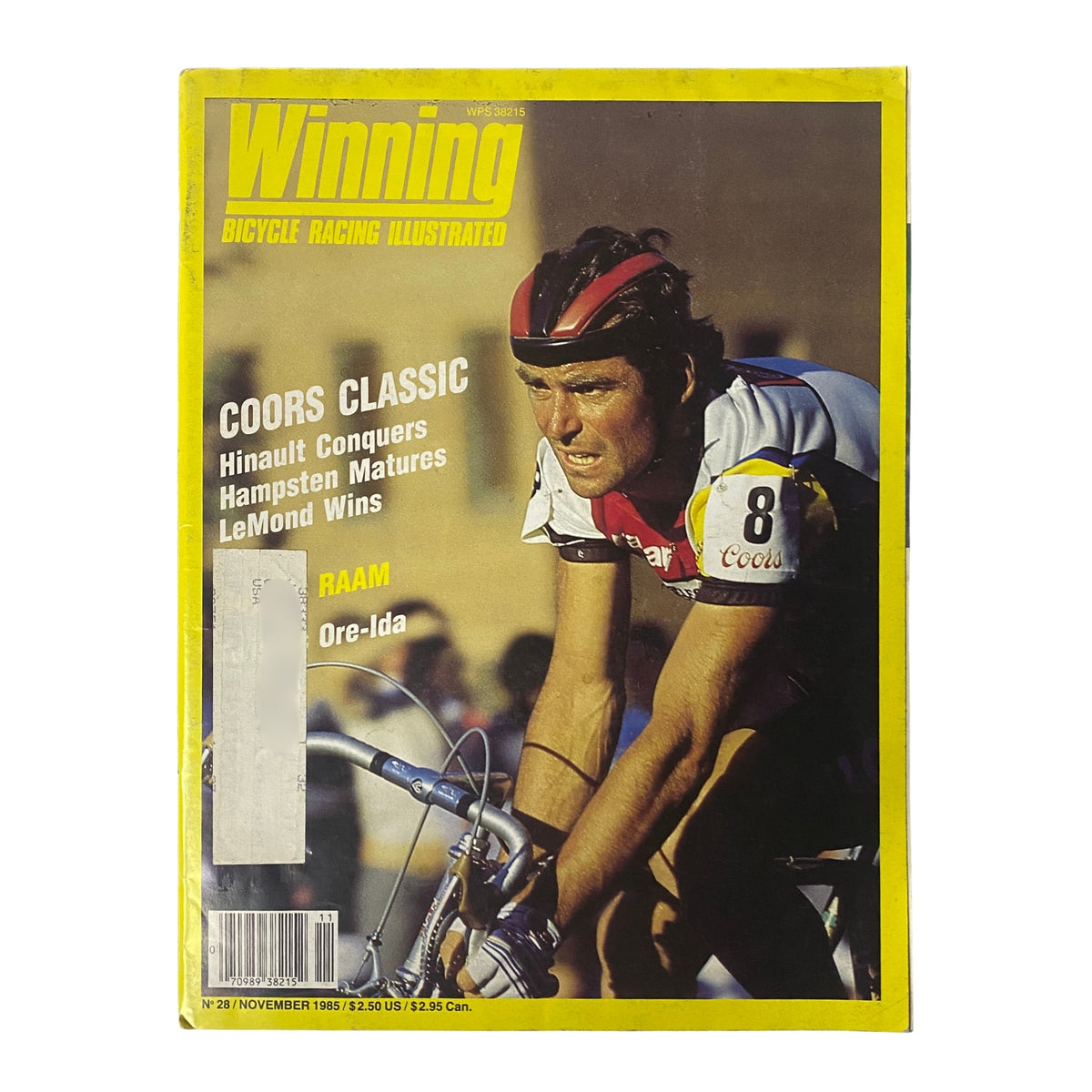 Cover of Winning Bicycle Racing Illustrated, November 1985, No. 28 featuring Bernard Hinault. The magazine highlights the Coors Classic with Bernard Hinault depicted in action on a bicycle.