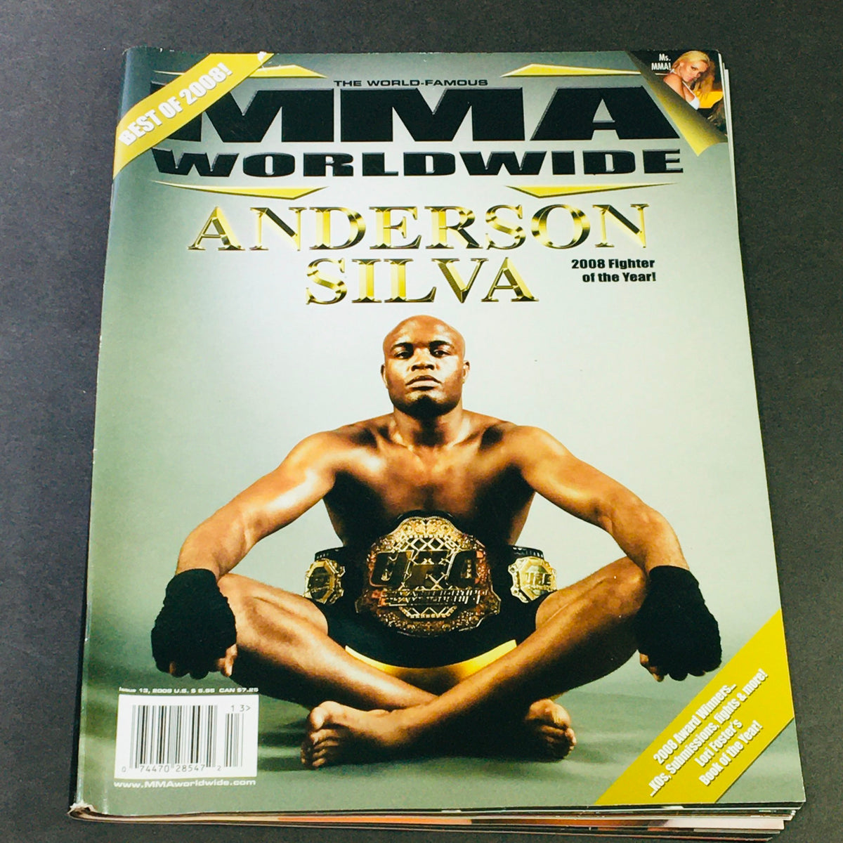 MMA Worldwide Magazine 2009 #13 featuring Anderson Silva, the 2008 Fighter of the Year, showcasing Silva sitting with his championship belts, capturing the essence of mixed martial arts in that era.