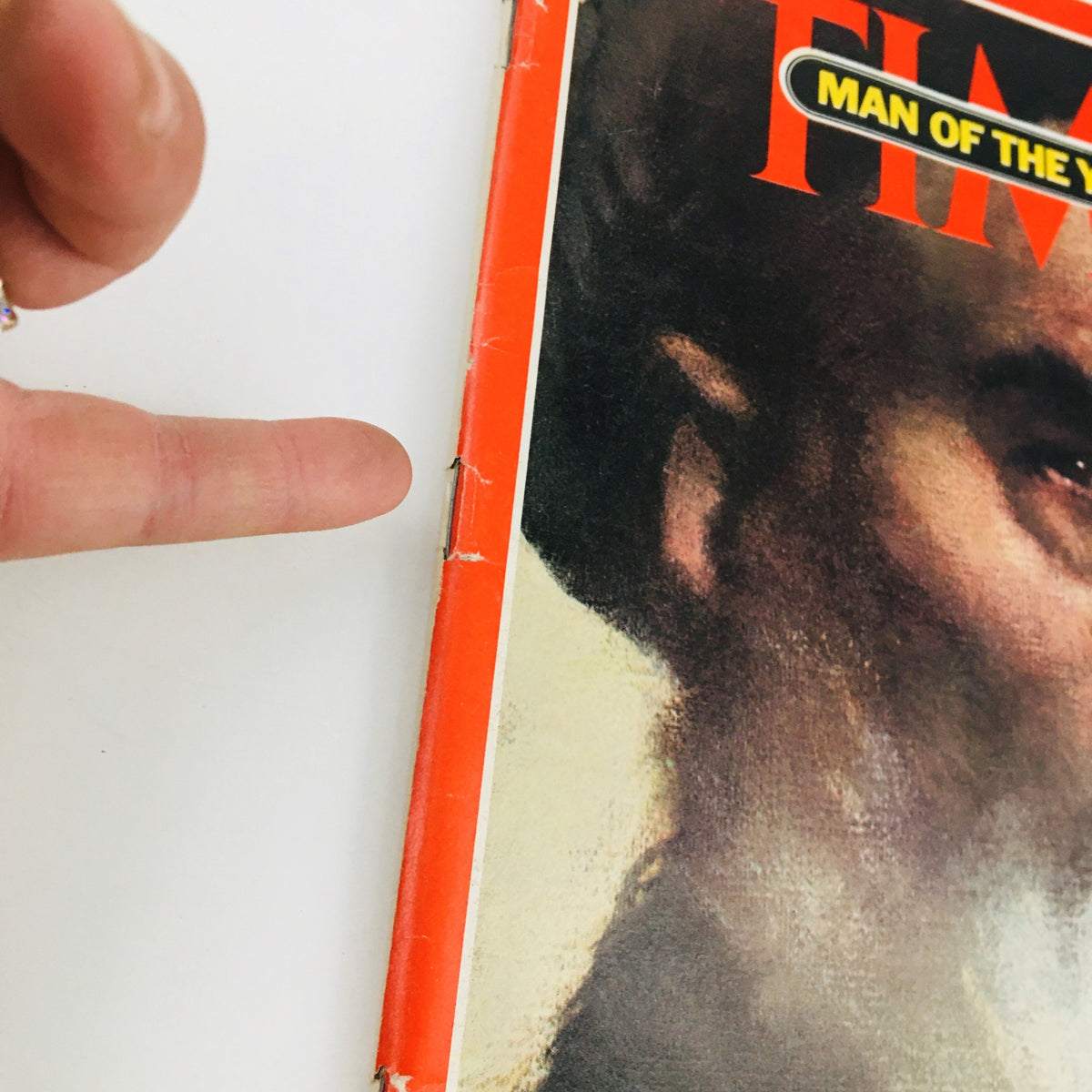 Close-up of the Time Magazine January 7, 1980, cover showing details of the artwork with the title 'MAN OF THE YEAR' and a partial view of the face depicted, emphasizing the notable features related to Ruhollah Khomeini.