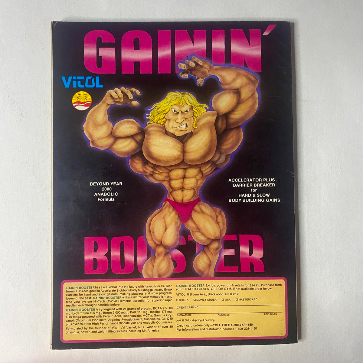 Back cover of IronMan Magazine May 1990 featuring an illustration of a muscular bodybuilder with promotional content for Gainin' Booster.