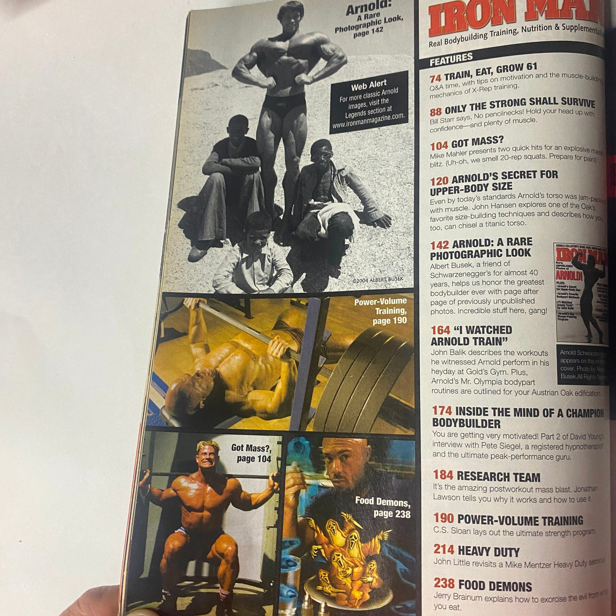 Inside pages of IronMan Magazine November 2004 highlight Arnold Schwarzenegger's favorite workout strategies, featuring images of training techniques such as Power-Volume Training and additional bodybuilding insights.