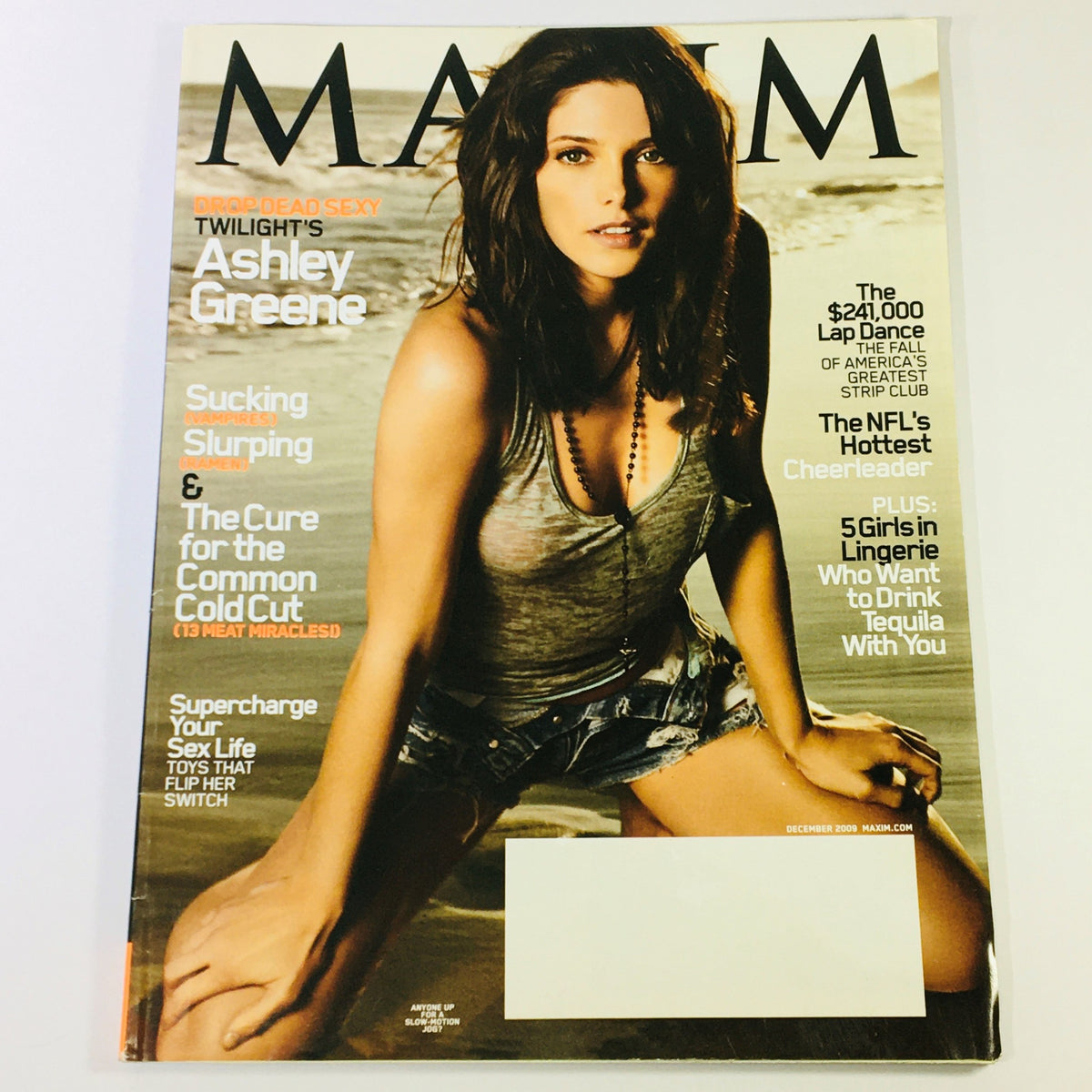 Maxim Magazine December 2009 featuring Twilight's Ashley Greene on the cover, showcasing a stylish image of the actress in a casual beach setting.