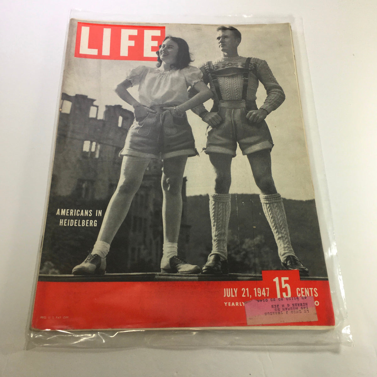 Life Magazine cover from July 21, 1947, featuring Americans in Heidelberg, showcasing a vintage photograph of a woman and a man in traditional German attire against a historic backdrop.