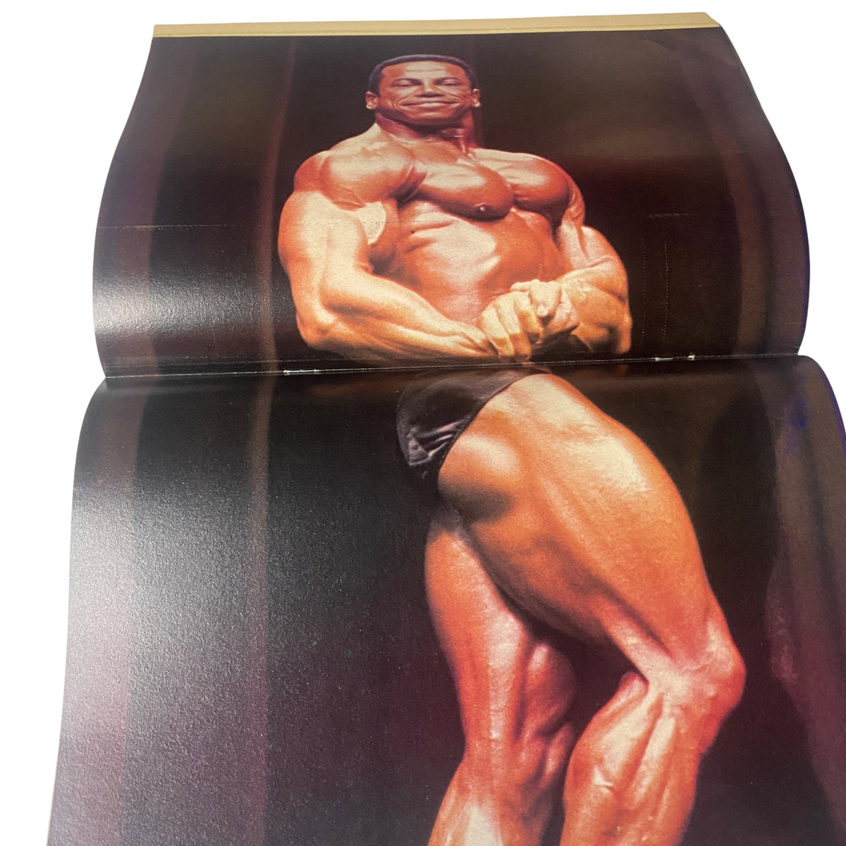 Image from Muscle & Bodybuilder Magazine May 1983 featuring a well-defined male bodybuilder showcasing impressive muscle definition and posing skills. This is an iconic centerfold from a vintage bodybuilding publication.