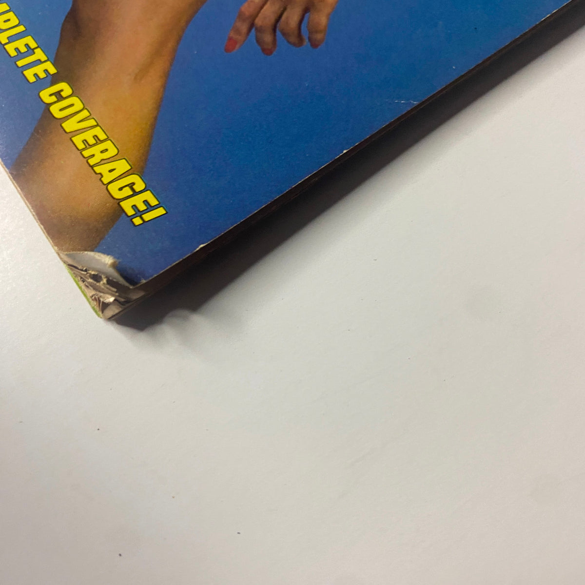 Close-up view of the corner of the October 1984 Muscle Training Illustrated magazine, showcasing light wear indicating its vintage condition.