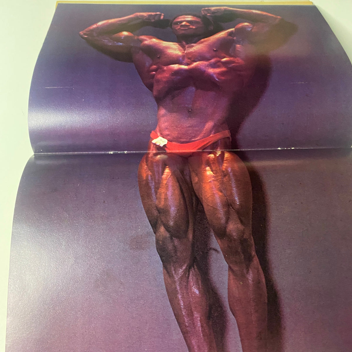 Centerfold image from Muscle World Magazine November 1981 showcasing a muscular bodybuilder posing, emphasizing leg and torso strength.