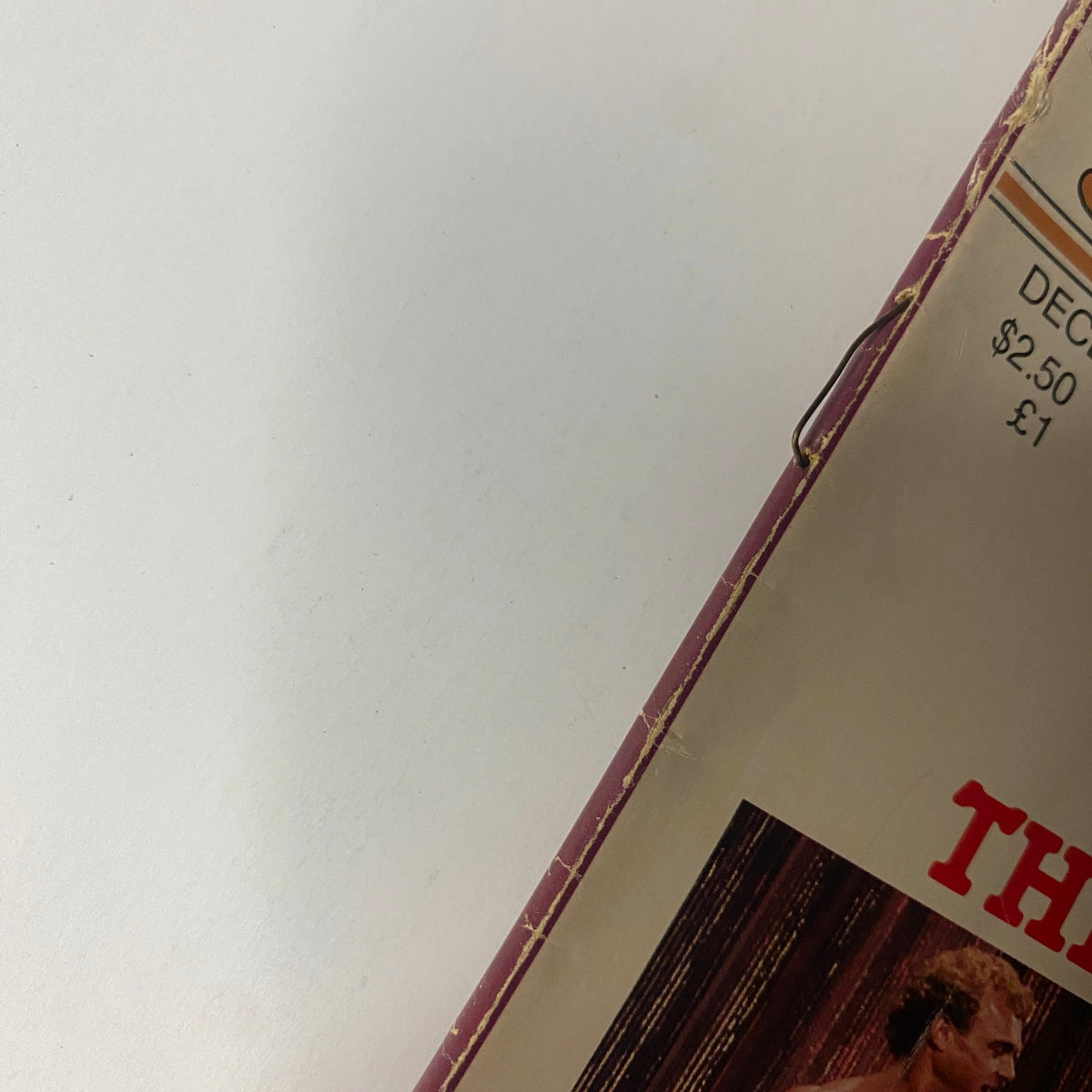 Close-up view of the top edge of Muscle Digest Magazine December 1981, featuring details of the magazine cover and decorative elements.