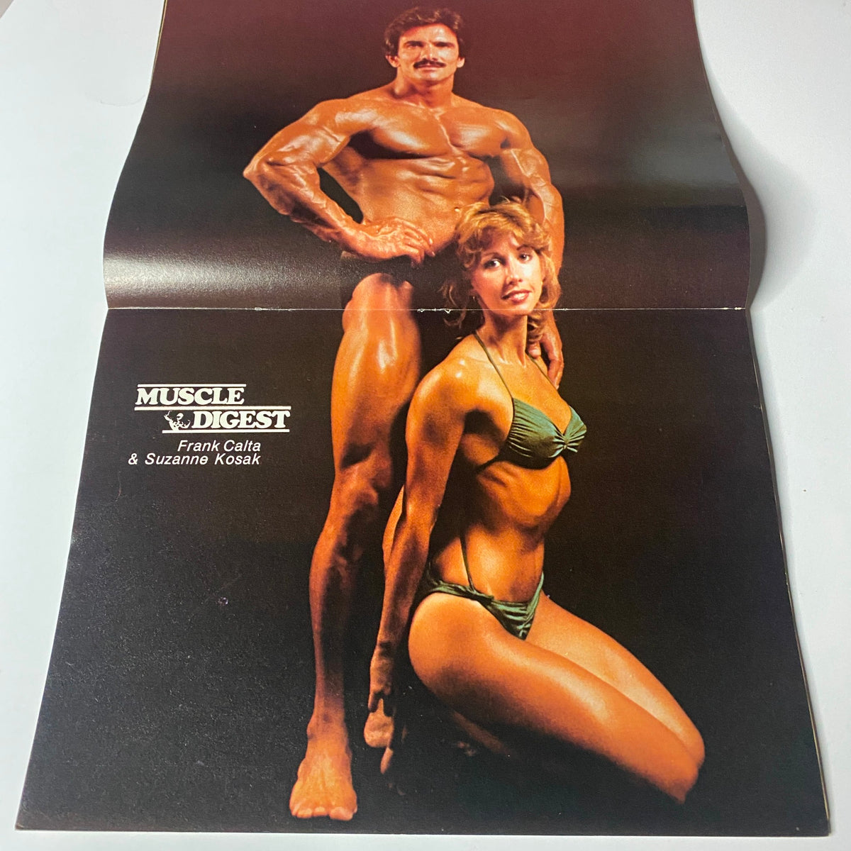 Centerfold of Muscle Digest Magazine August 1981, featuring Frank Calta and Suzanne Kosak posing in fitness attire.