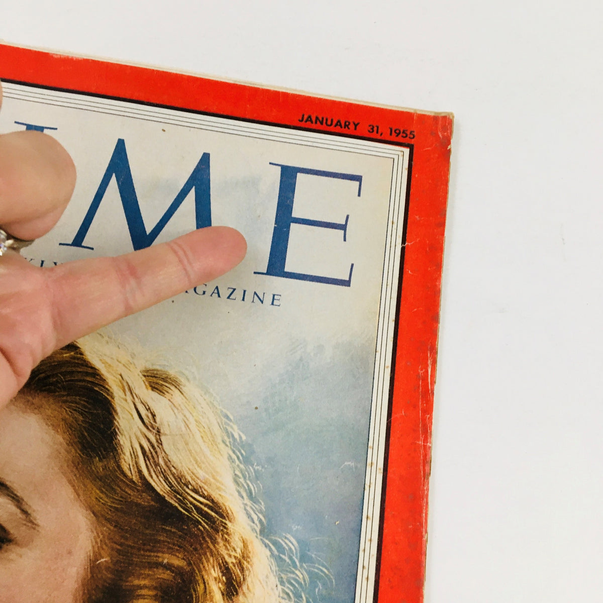 Close-up of the Time Magazine cover from January 31, 1955, showing the vibrant title and the image of Grace Kelly, highlighting minor wear and an address label.