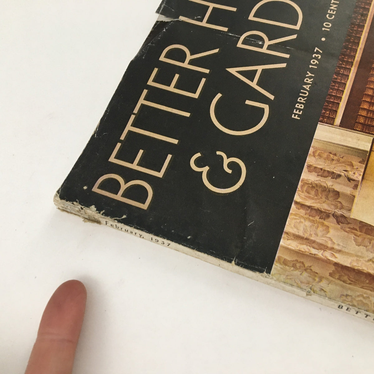 Close-up view of the damaged cover of Better Homes & Gardens February 1937 magazine, showcasing the title and publication date.