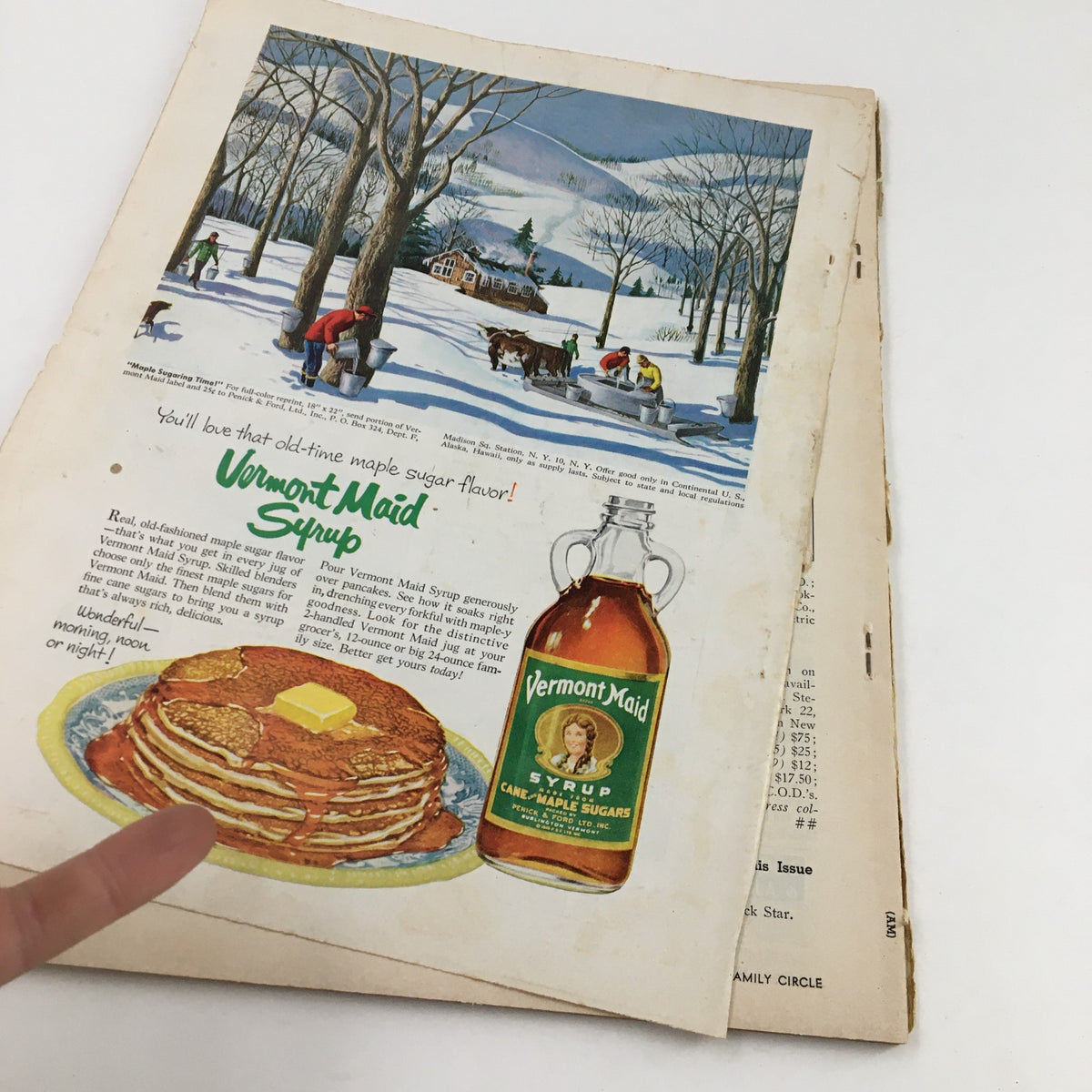 Inside page of Family Circle Magazine December 1954 showcasing an advertisement for Vermont Maid Syrup with pancakes and a winter scene.
