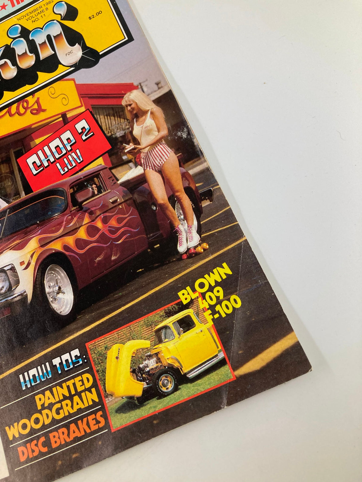 Close-up of Truckin Magazine November 1982 cover, highlighting the Rocky Van, Big-Buck '48 Chevy, and a model in roller skates, emphasizing vintage automotive culture.