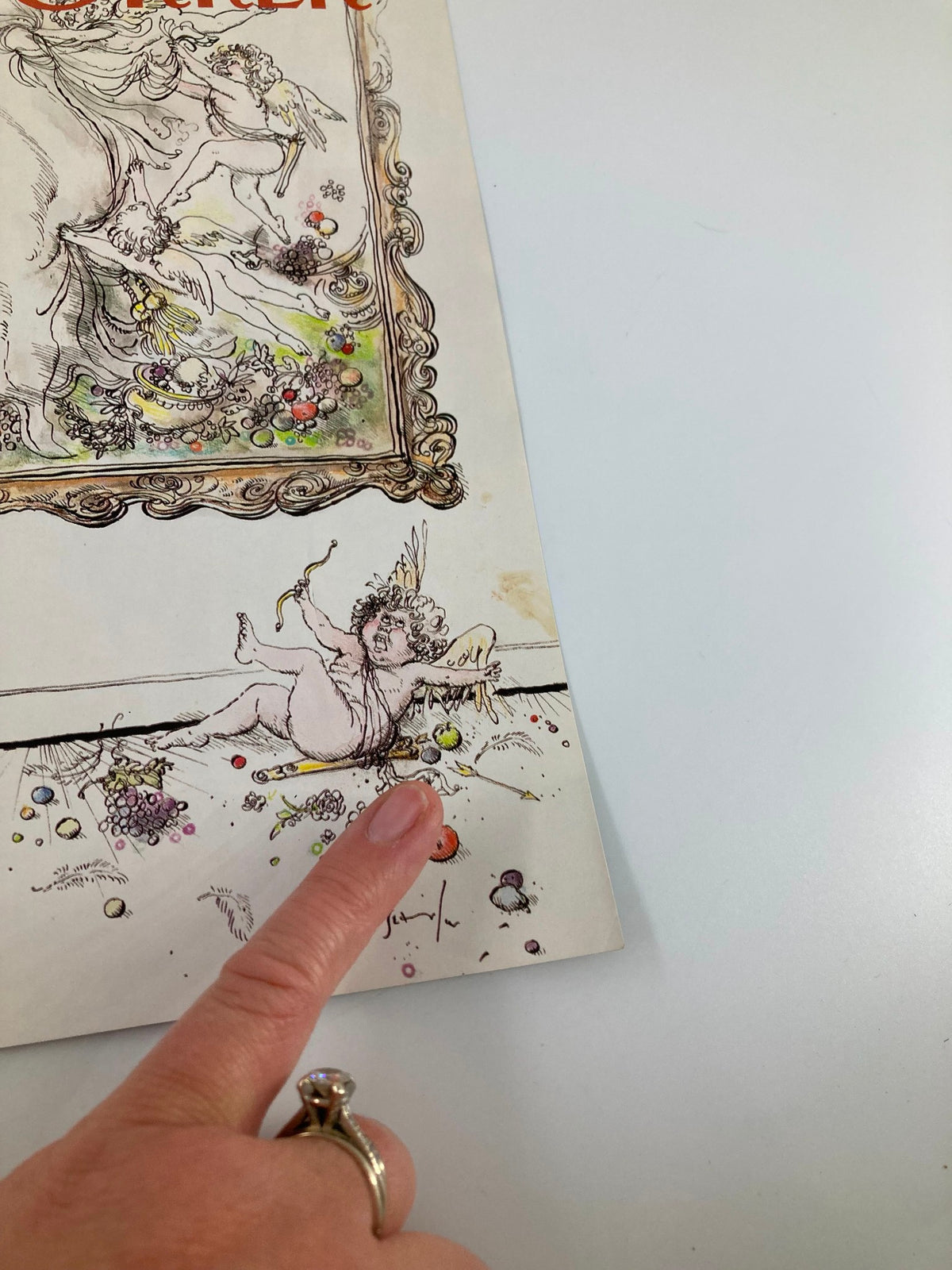 Close-up view of The New Yorker cover from December 5, 1988 titled 'Angel's a Mess' by Ronald Searle, showing whimsical illustration and playful details, accompanied by a hand pointing at the artwork.