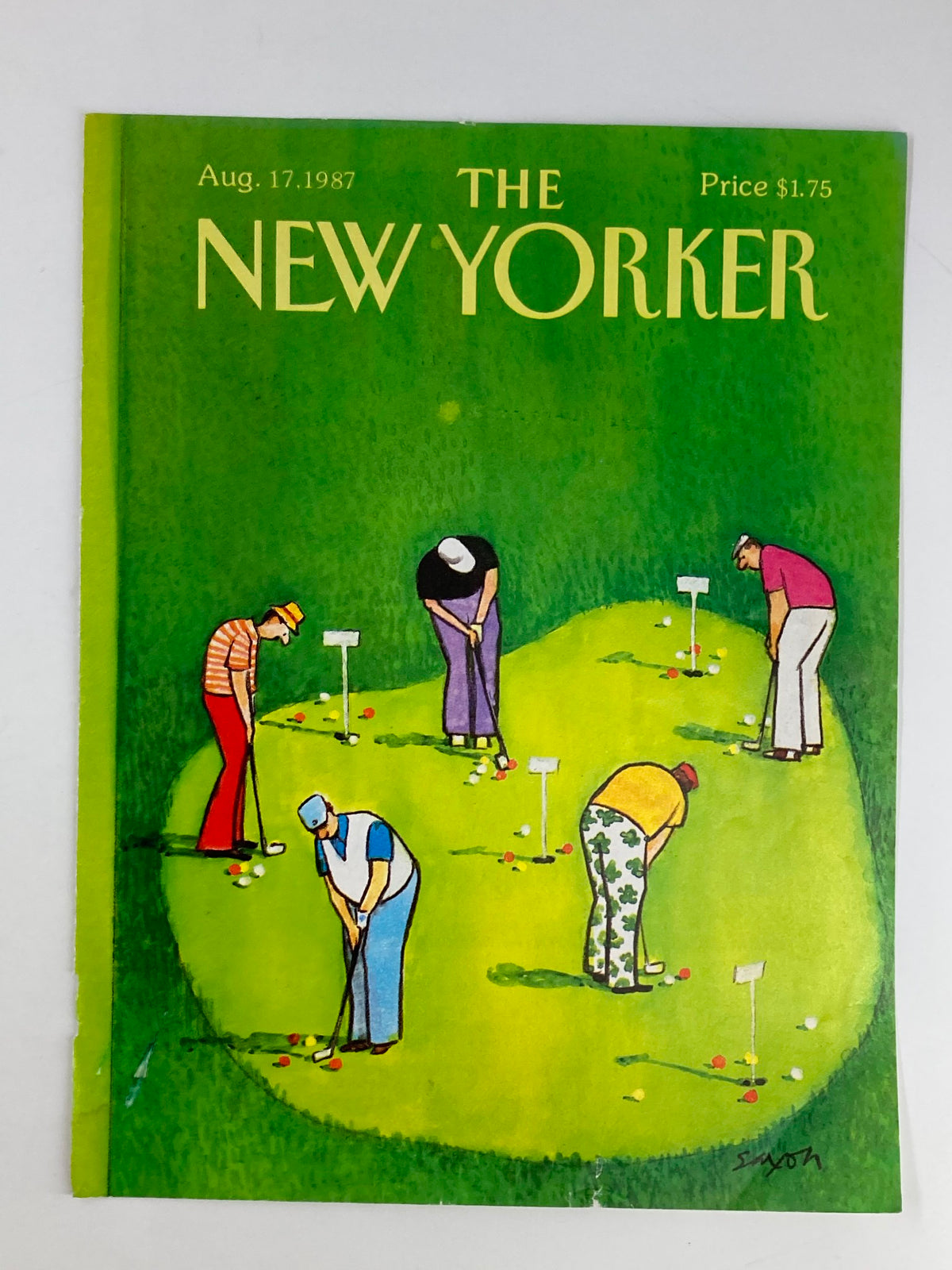 The New Yorker Cover Art from August 17, 1987, featuring a colorful illustration by Charles Saxon depicting a group of golfers on a putting green, showcasing a lighthearted scene of leisure and camaraderie.
