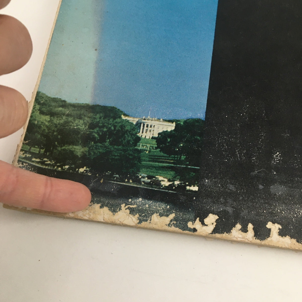 Detail of the bottom edge of the Holiday Magazine May 1956 cover, emphasizing age-related wear.