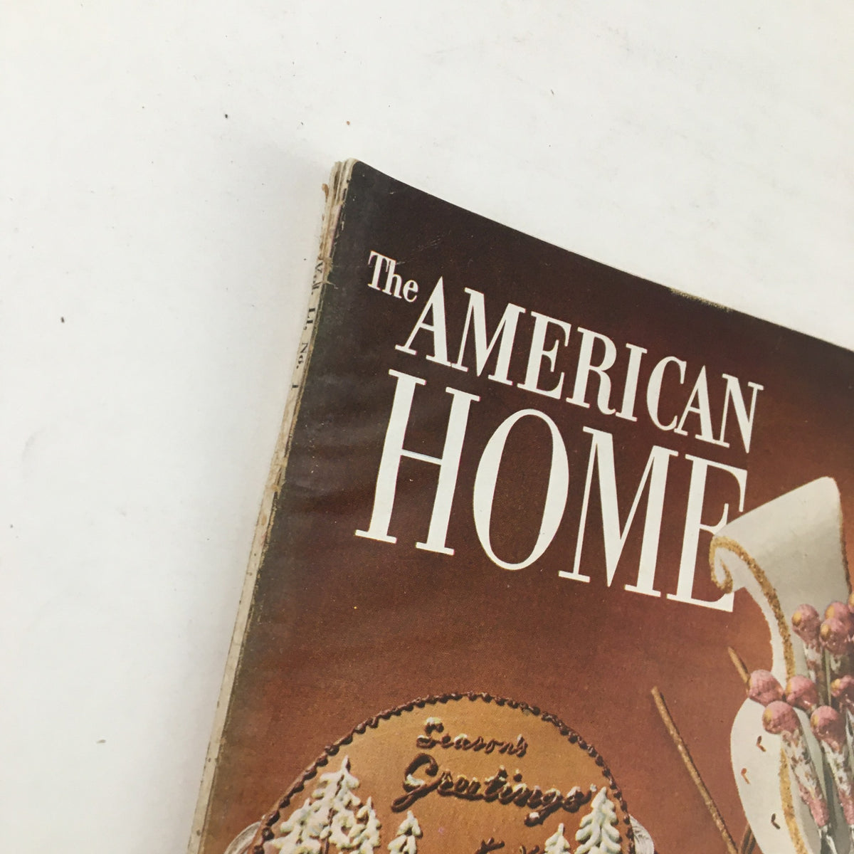 Close-up of the spine of The American Home Magazine December 1953 showing the title 'The American Home' and the festive theme.