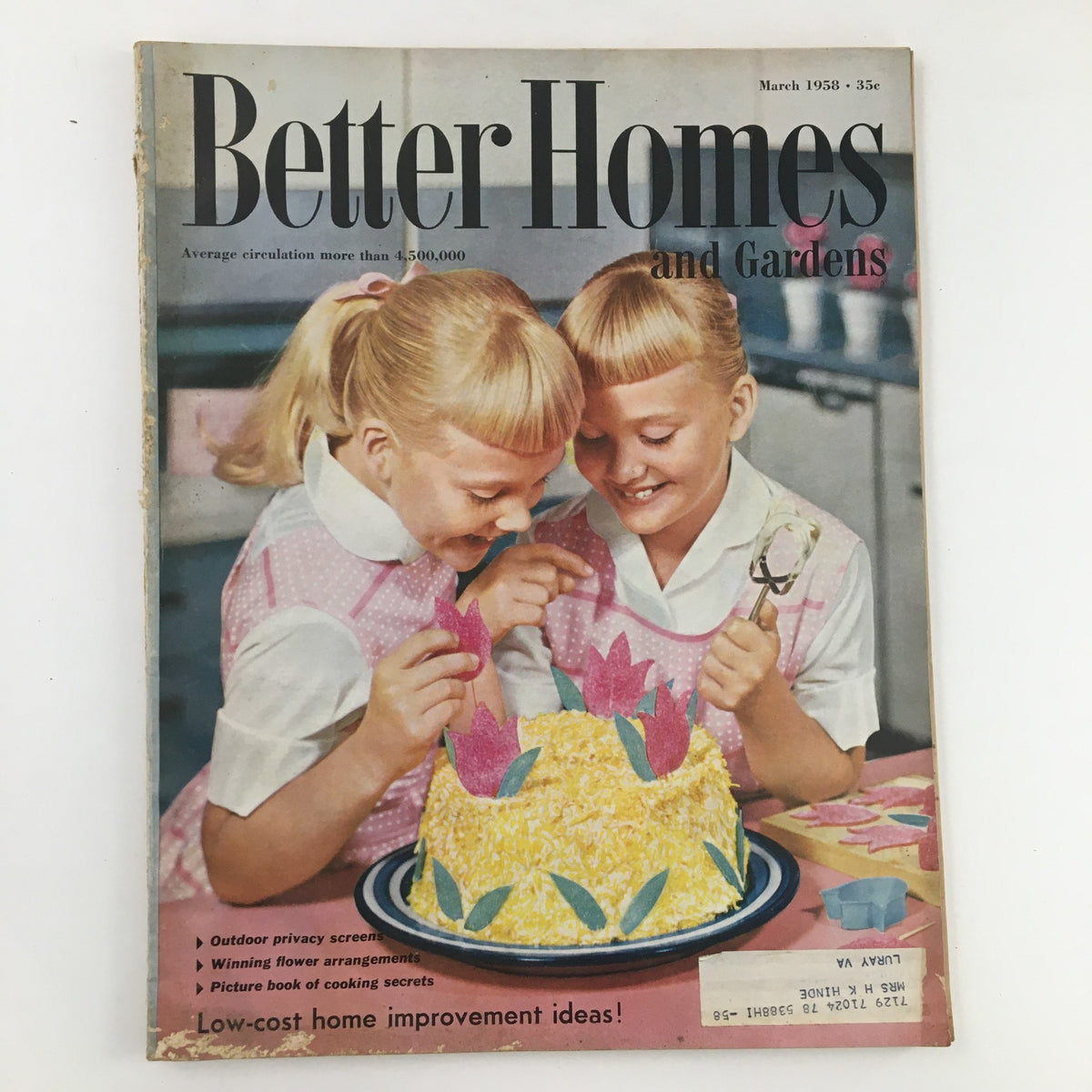 Cover of Better Homes & Gardens March 1958 featuring two girls decorating a cake, highlighting the article "Cheese Wanders from your Chafing Dishes" along with vibrant culinary themes.