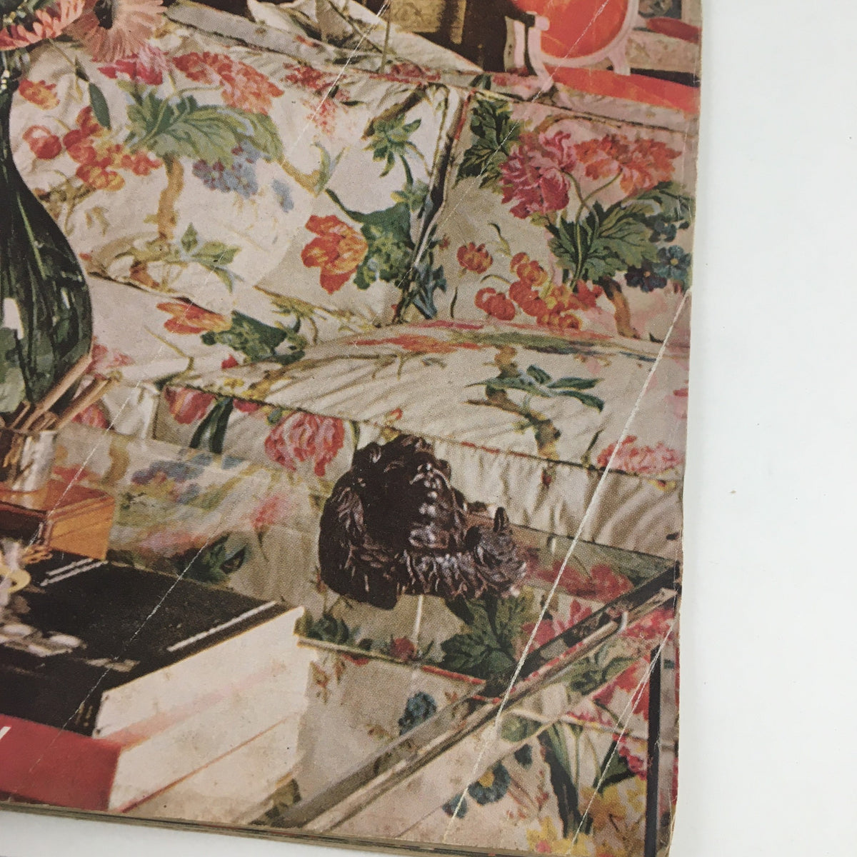 Close-up of the floral arrangement and patterned couch featured on the cover of American Home Magazine June 1968, showcasing vintage decor elements.