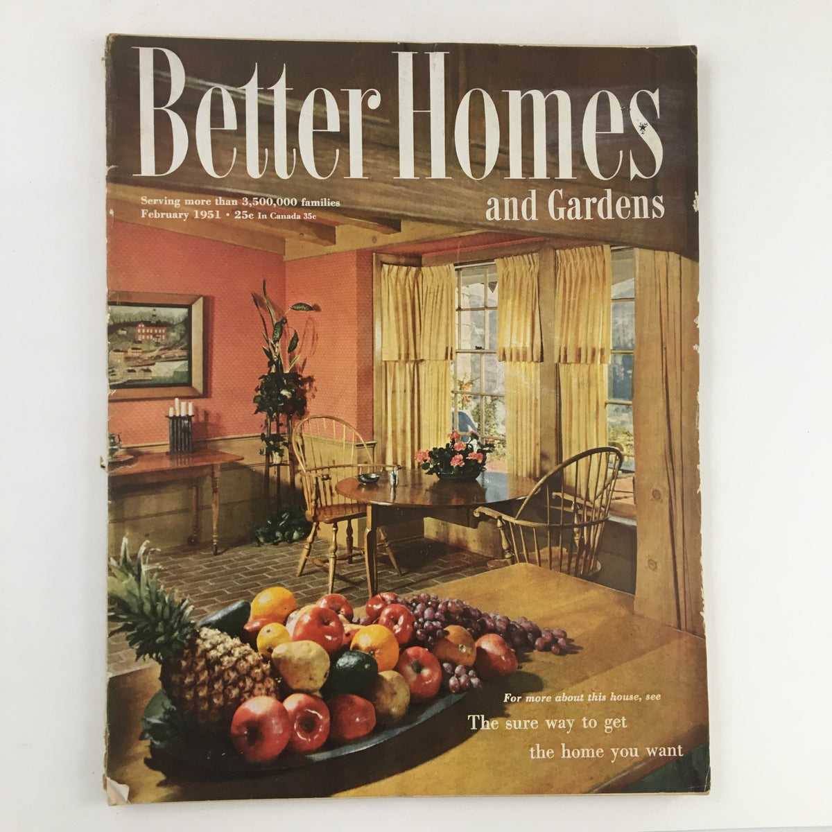Cover of Better Homes & Gardens February 1951 vintage magazine featuring a cozy domestic setting with fruit centerpiece.