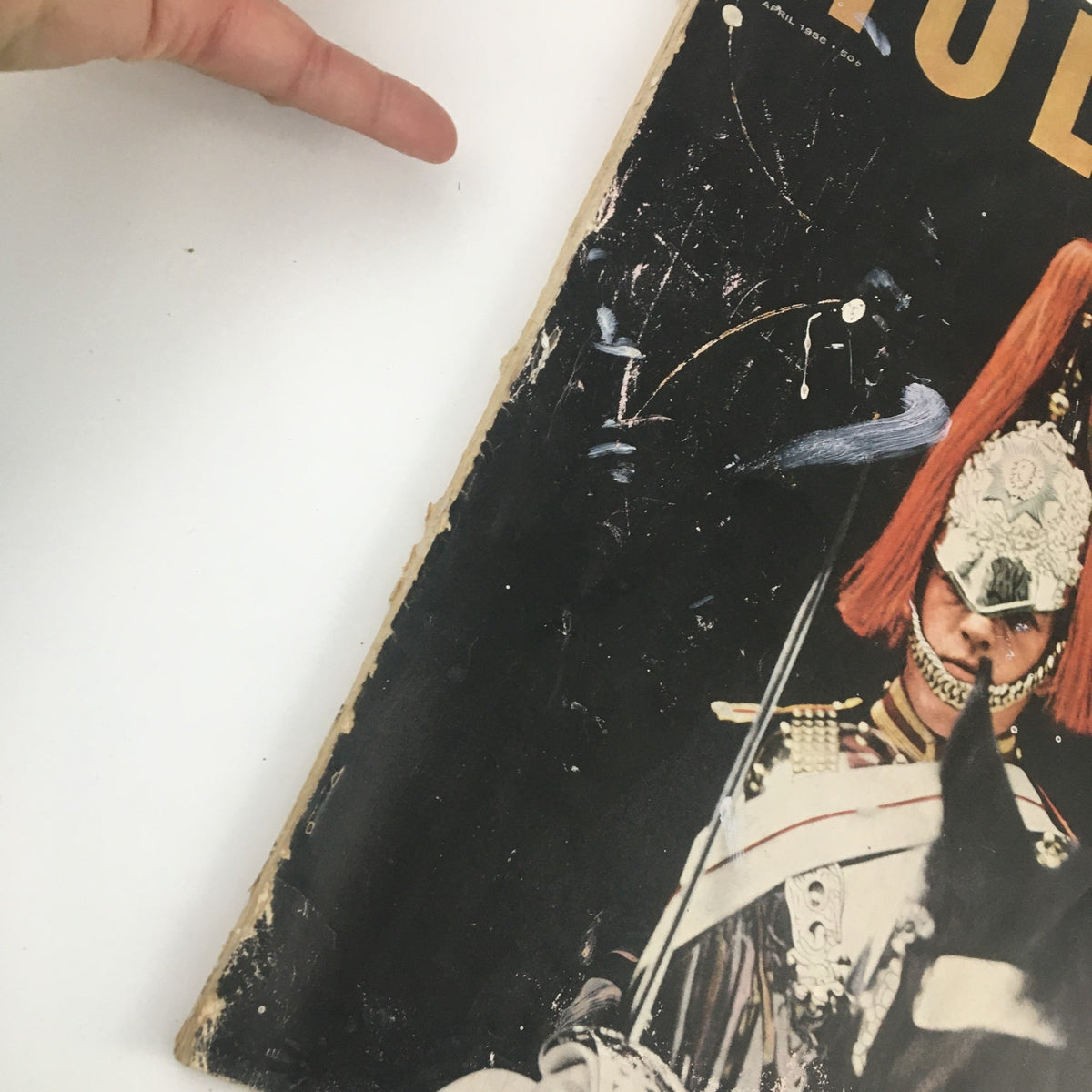 Side view of the damaged cover of Holiday Magazine April 1956 titled 'William Shakespeare's Raffish London', showing wear and tear.