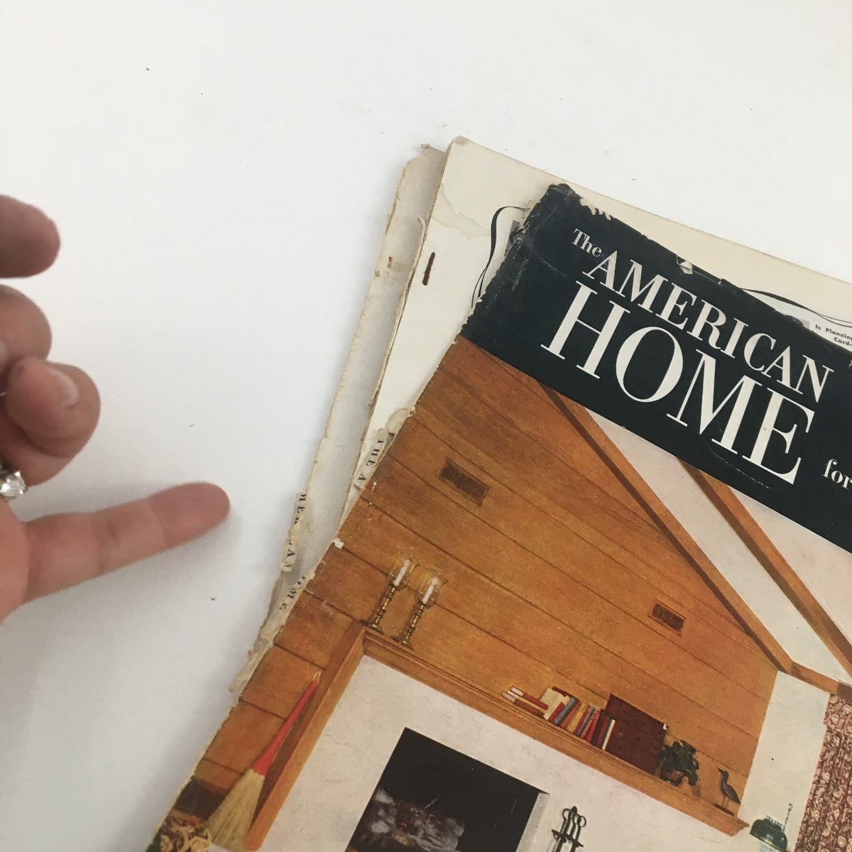 Side view of American Home Magazine January 1951, featuring worn edges and an intriguing glimpse of mid-century interior design theme.