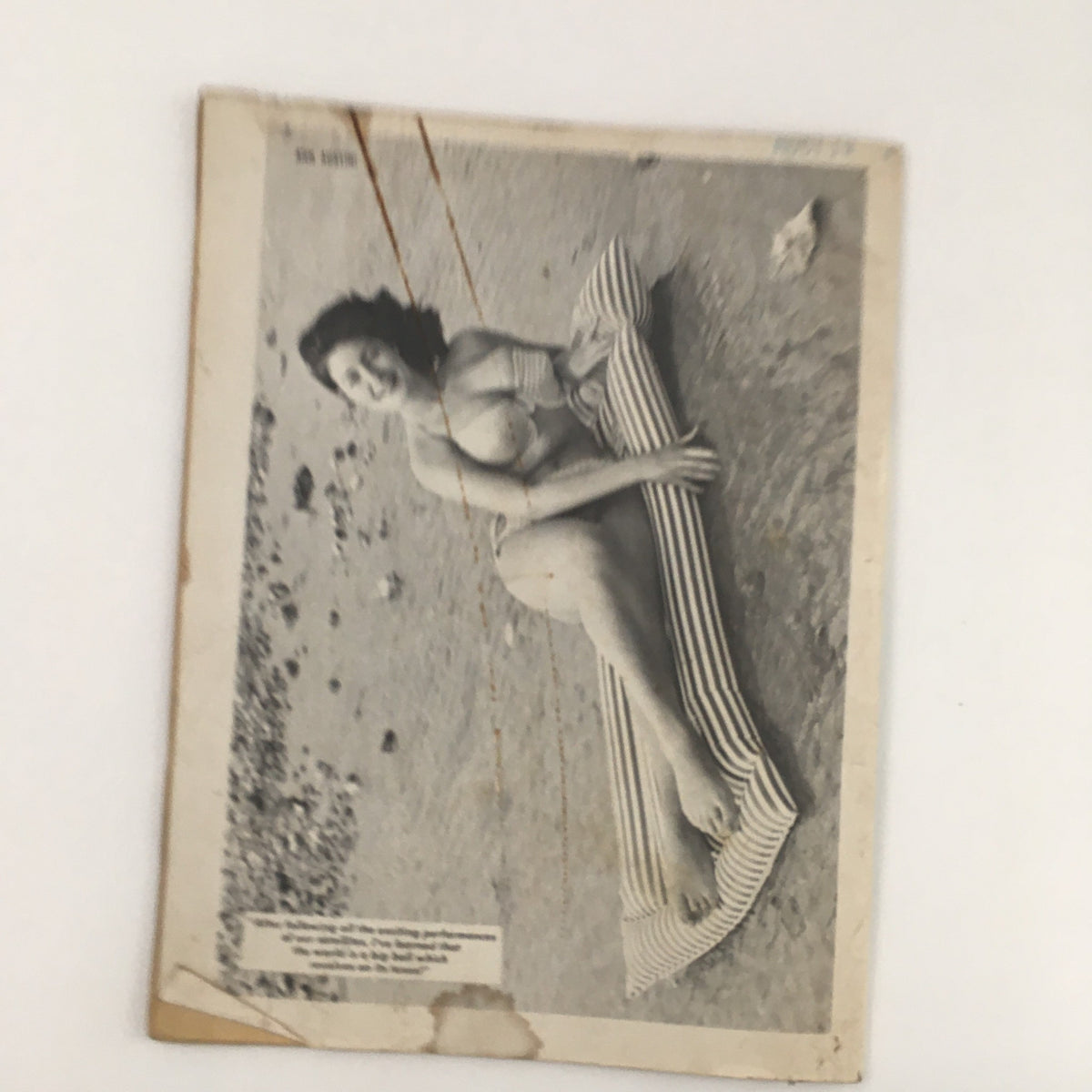 A pin-up style photo from Popular Cartoons January 1968, depicting a model lounging by the beach, showcasing vintage aesthetics of the era.