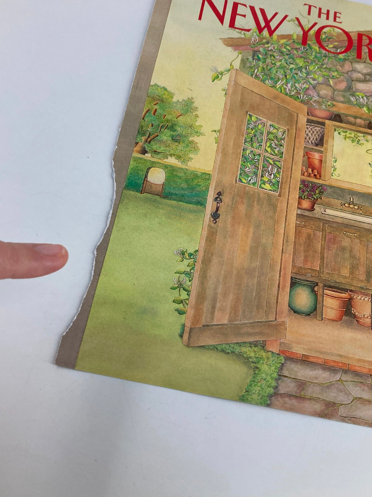 Close-up view of The New Yorker cover from July 10, 1989, titled 'Garden Shed' by Jenni Oliver, highlighting the magazine's rustic details and natural wear along the edge.