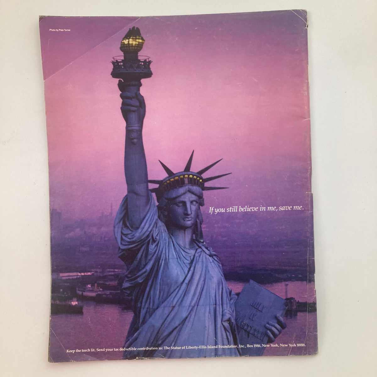 Back cover of Life Magazine Summer 1984 Vol 7 No. 7 showcasing the Statue of Liberty during sunset with the phrase 'If you still believe in me, save me,' emphasizing themes of hope and history.