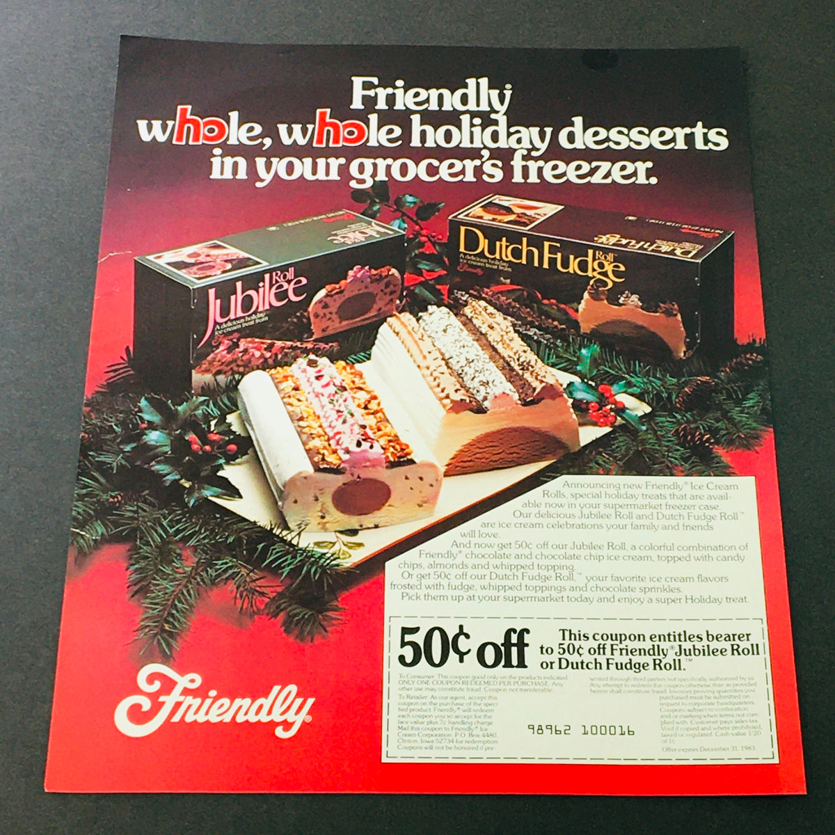 VTG Retro 1983 Friendly Jubilee Roll or Dutch Fudge Roll Desserts Ad Coupon featuring a colorful display of desserts with holiday decorations and a promotional offer for 50 cents off.