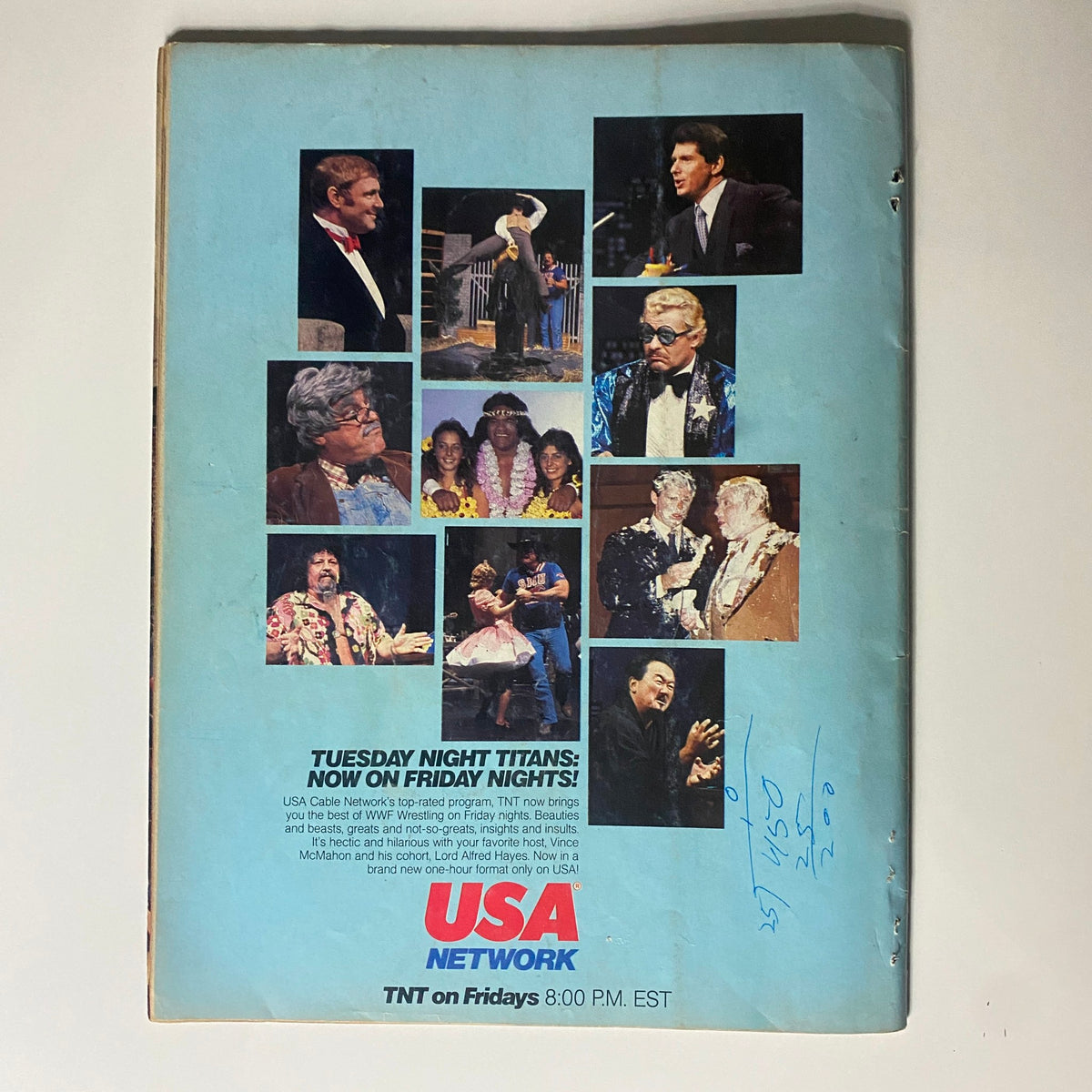 Cover image of the back side of the VTG WWF Wrestling Magazine August 1985, featuring a collage of iconic wrestling personalities and promotional details about the 'USA Network' programming. A perfect memorabilia piece.