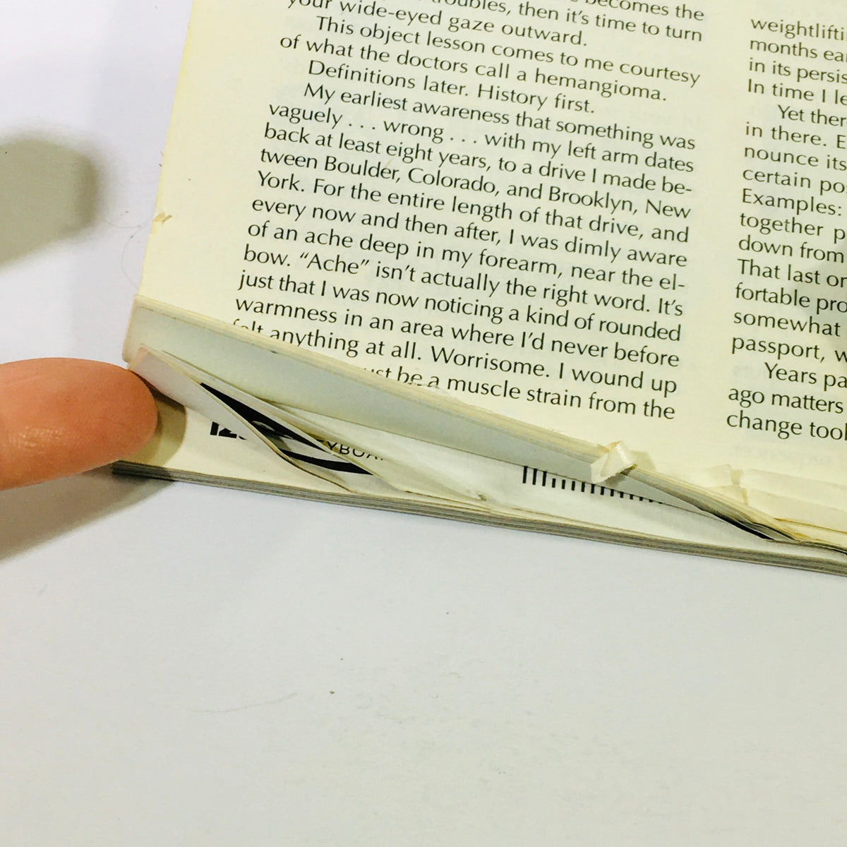 Close-up view of the spine of the Keyboard Magazine October 1996, showcasing wear and tear, indicative of its used condition. The image highlights features on the edge of the magazine, including minor creases and a visible finger pointing, emphasizing the magazine's vintage quality.