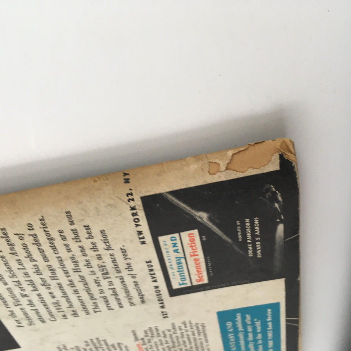 Damaged corner of the back cover of Fantasy and Science Fiction October 1959, providing insight into the magazine's vintage condition and historical significance.