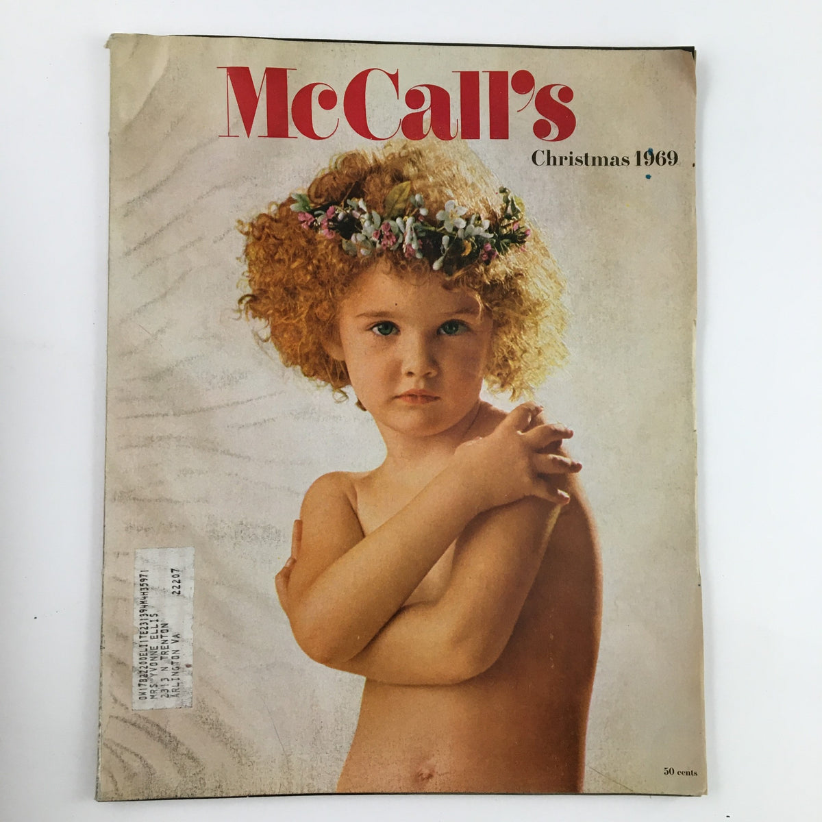 Cover of McCall's Magazine December 1969 featuring a young girl with curly hair and a floral crown, representing the theme of Between Parent and Child, Holidays and Children.