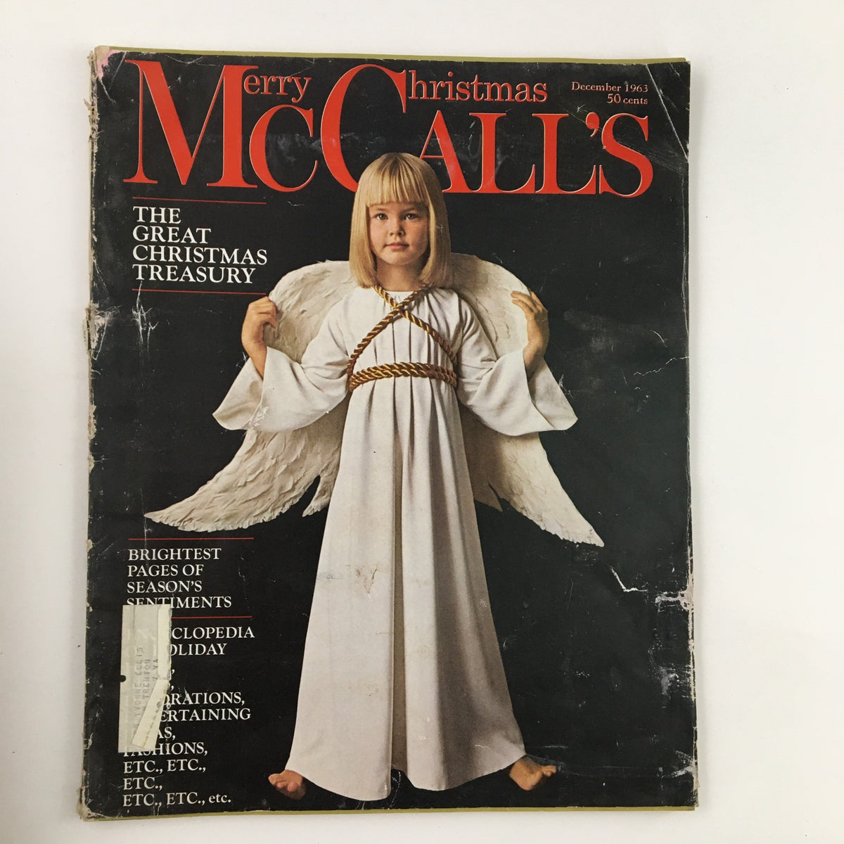 Cover of McCall's Magazine December 1963 featuring a child dressed as an angel with wings, showcasing the theme 'The Great Christmas Treasury'.