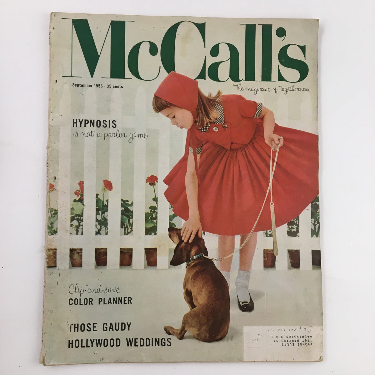 Cover of McCall's Magazine September 1956 featuring a young girl in a red dress interacting with a dog, highlighting the article on hypnosis and those gaudy Hollywood weddings.