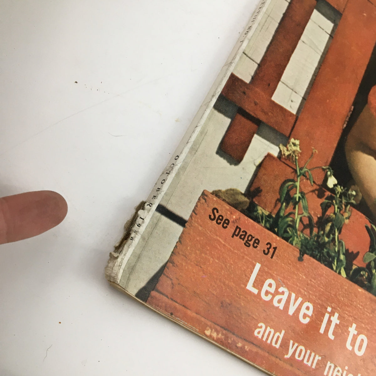 Close-up of the spine of McCall's Magazine October 1950, showing wear and a vintage address label, adding character to this historical publication.