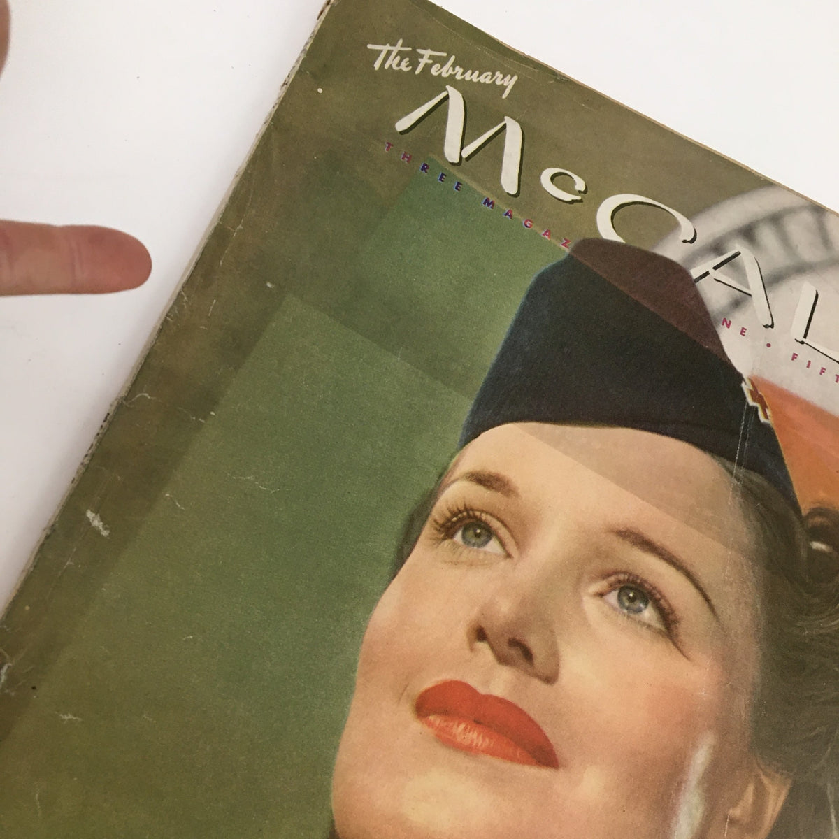 Cover of McCall's Magazine February 1945 featuring a close-up of a woman with red lipstick and a stylish hat, showcasing vintage fashion themes from the era.