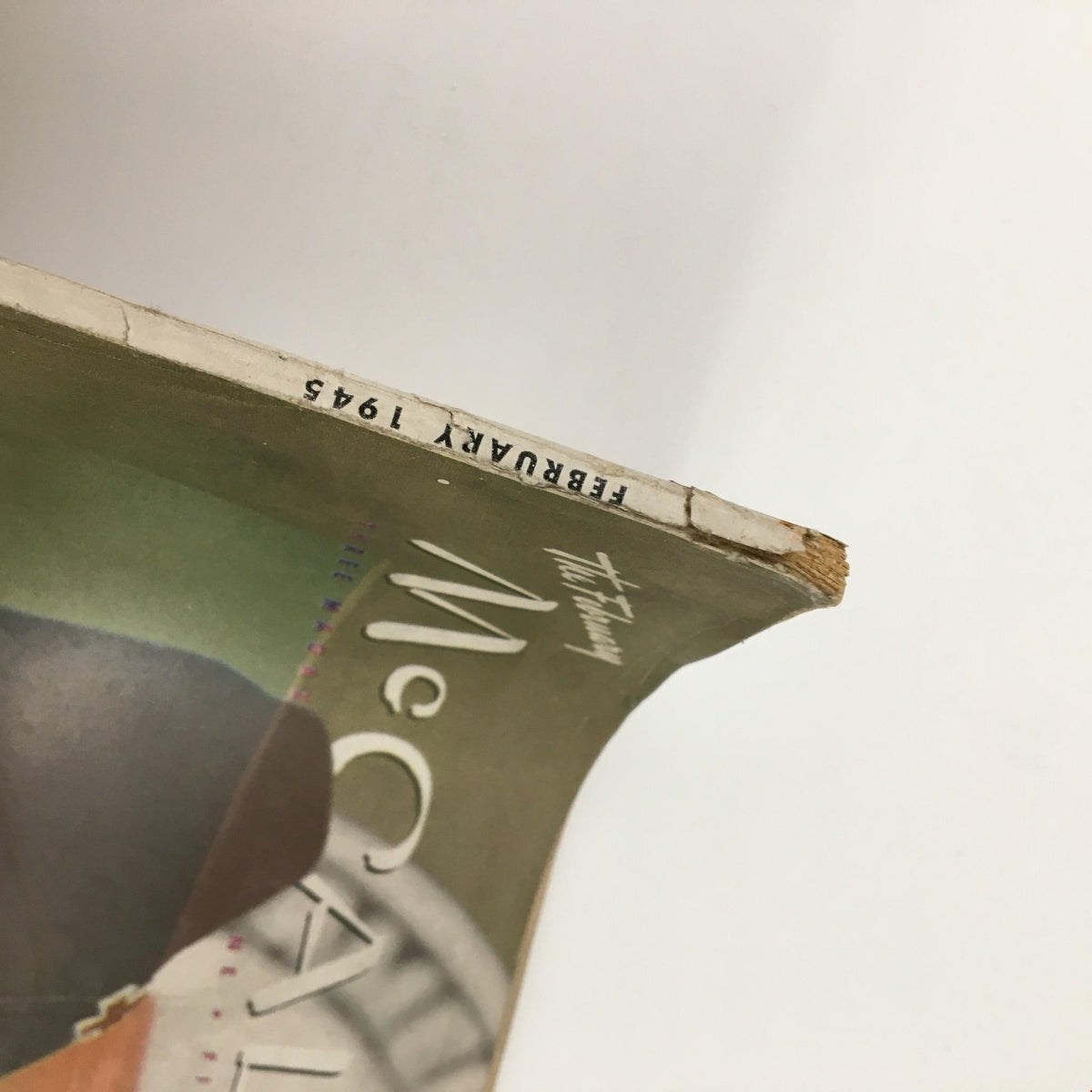 Side view of McCall's Magazine February 1945 showing the spine with the date clearly printed, adding to the vintage appeal.
