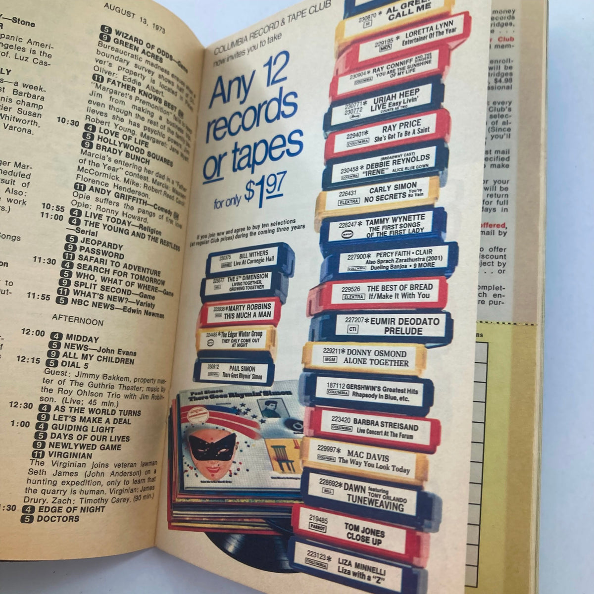 Another interior page of TV Guide Magazine August 11, 1973, issue number 563, featuring an advertisement for Columbia Record & Tape Club, highlighting how customers can acquire 12 records or tapes for only $1.97. This page reflects the popular media of the era.