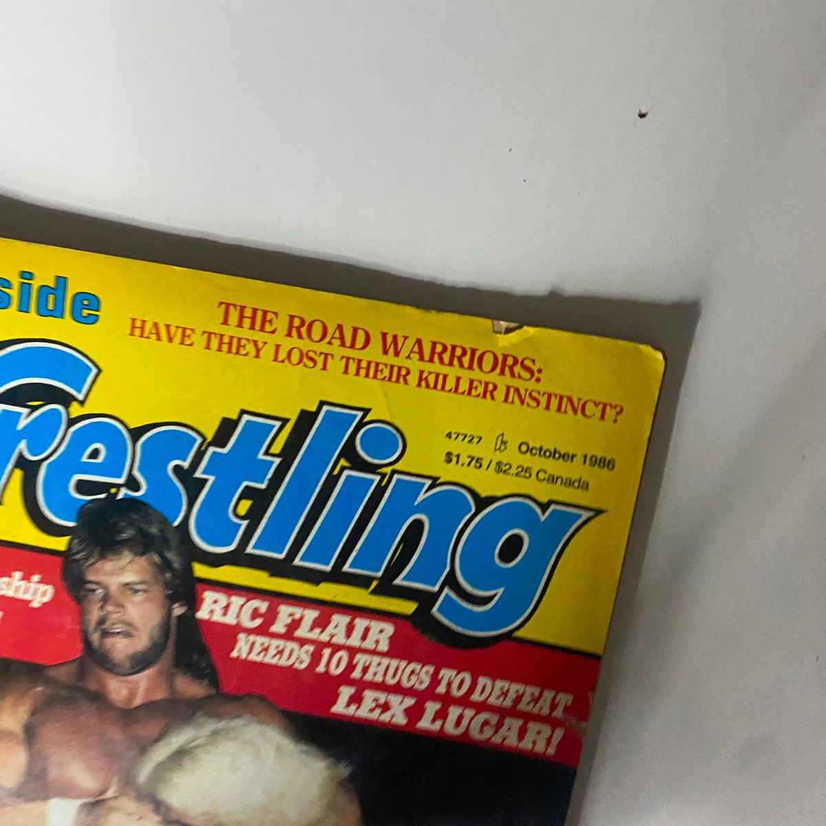 Close-up of the Inside Wrestling Magazine cover from October 1986, highlighting Ric Flair and Randy Savage, featuring headlines about wrestling championships.